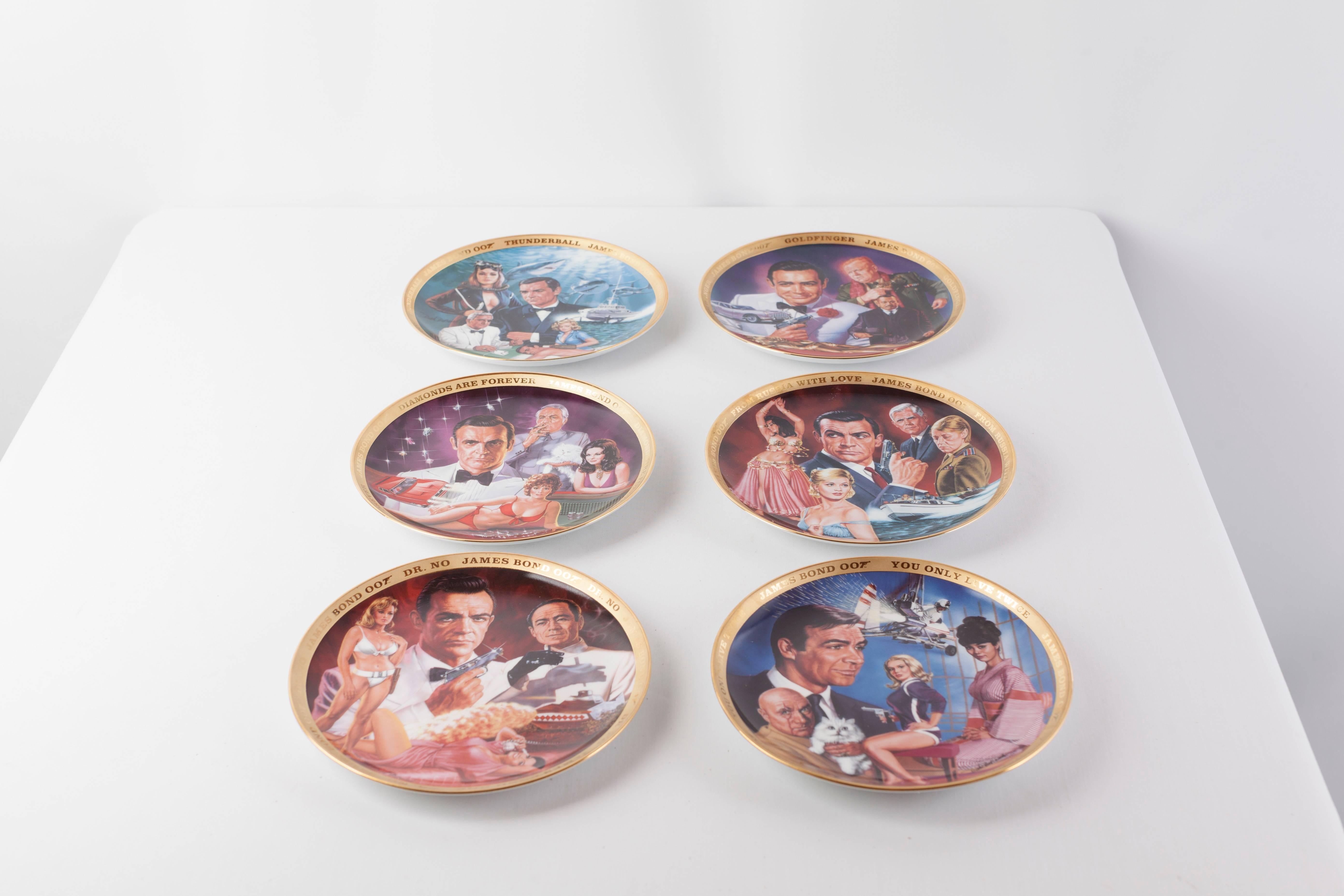 Set of six Decorative James Bond Plates featuring the work of Dick Bobnick made by Franklin Mint.
Each fine porcelain plate has a gold plated rim and is individually numbered in the same 24 Karat Gold. 
The plates commemorate the first six Bond