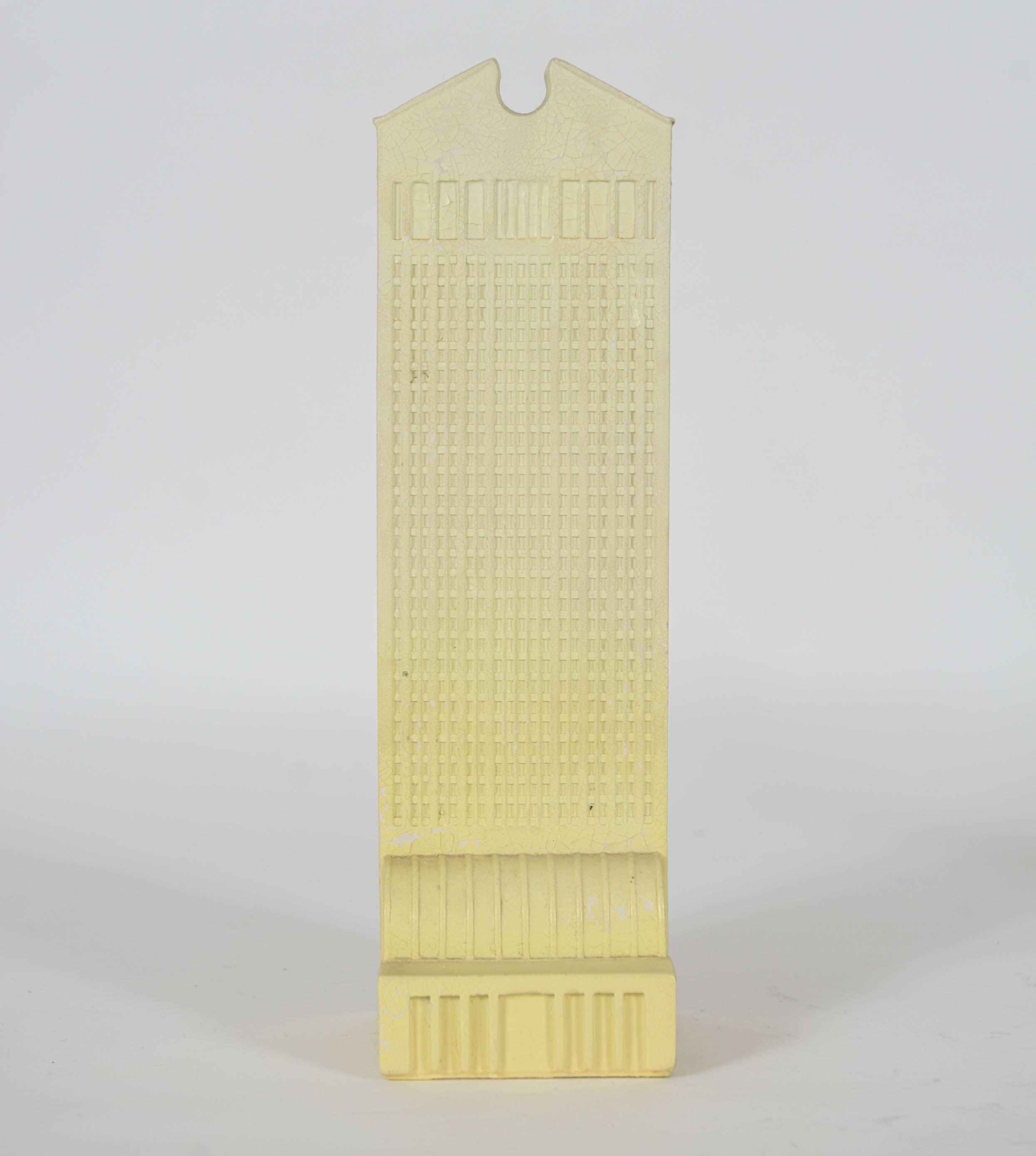 These two miniature skyscrapers were creatde by Johhny Dell'Orto for La Fabbrica di Dedato.

The blue one is the Transamerica Piramid by William Pereira, built in 1972 in San Francisco.
The yellow one we do not recognize. 

The yellow and blue