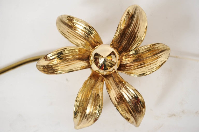 Two Flower shaped Brass Sconces coupled together by a tube.
Very warm and ambient light.
Made in the 1970s.
Attributed to the Belgian designer Willy Daro.