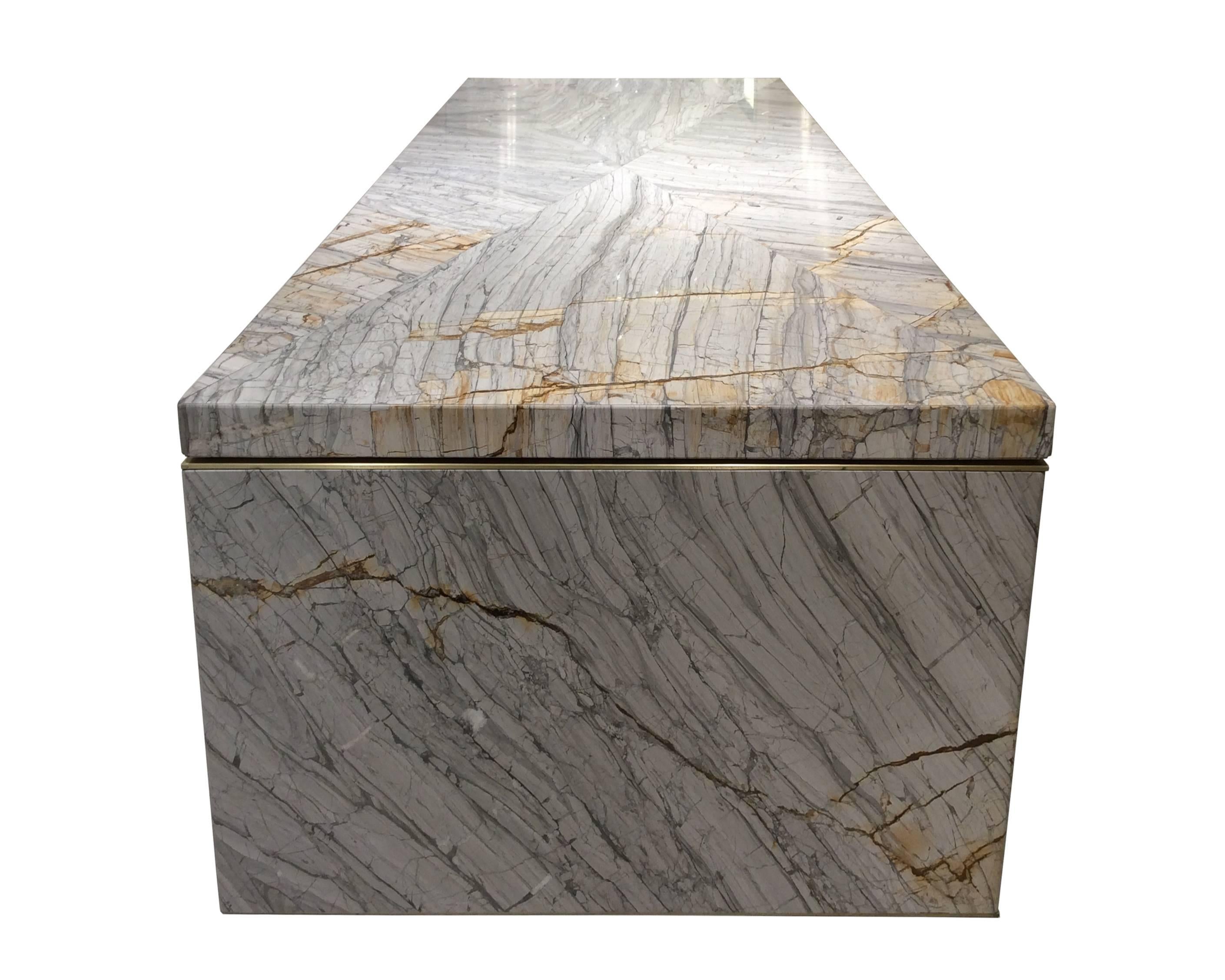 Gabriel Scott Turkish Marble Dining Table available from LMD/studio. 

One of a kind, custom-made waterfall style dining table by designer Gabriel Scot featuring Turkish marble slab and a matte brass under structure.