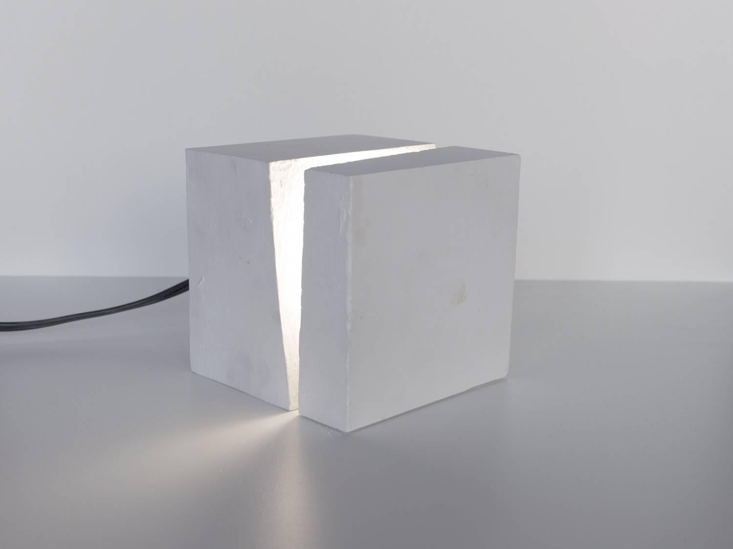 Cast light consists of a single long-life LED light bulb cast within a solid cubic volume of white gypsum cement. Each fixture is a unique object that can be used as a table lamp or accent lighting. With normal usage, Cast Light is expected to last