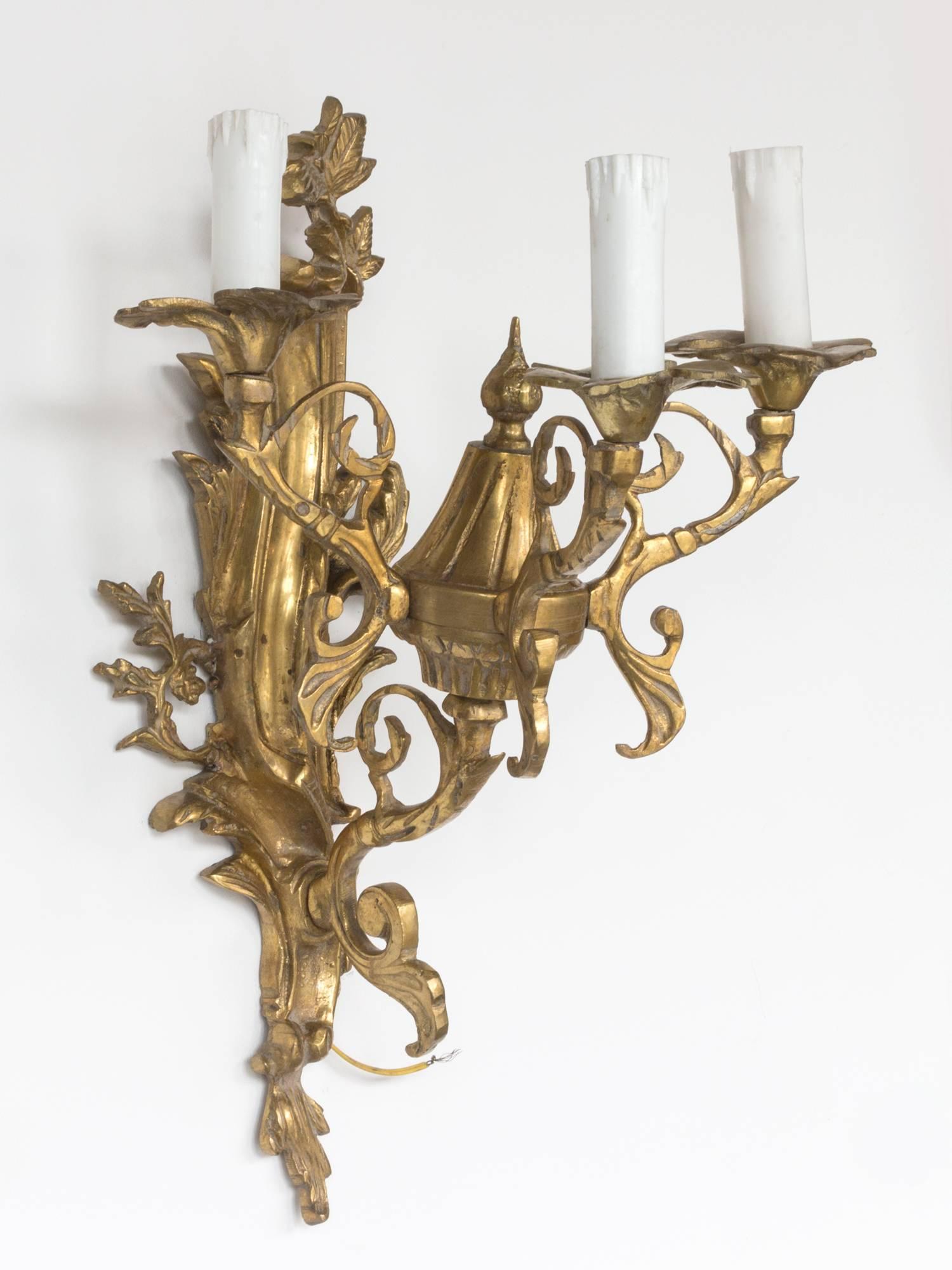 19th century gilded bronze French wall sconces.

Ornate Louis XVI style wall lights from the late 19th century (circa 1890s) from an apartment in Paris. 

The gilded bronze design features ornamentation of foilage, tassles and bows. The fixtures