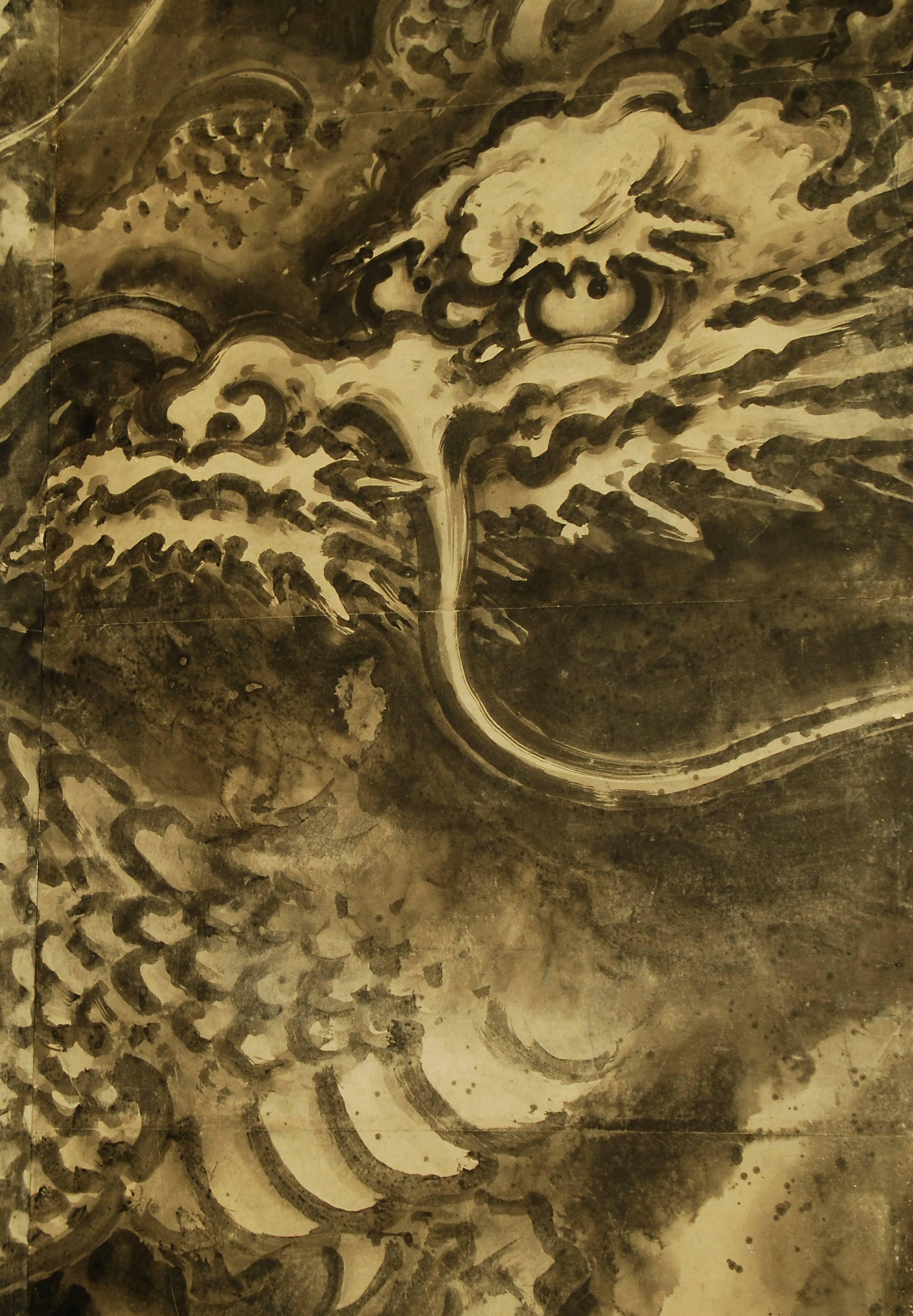 Japanese six-panel Kano School screen with a boldly painted depiction of a writhing dragon, rendered in ink on paper. Attributed to Kano Tanyu (1602-1674), 17th century signed and sealed.

Dimensions: H 173 cm x W 370 cm.

Here the dragon