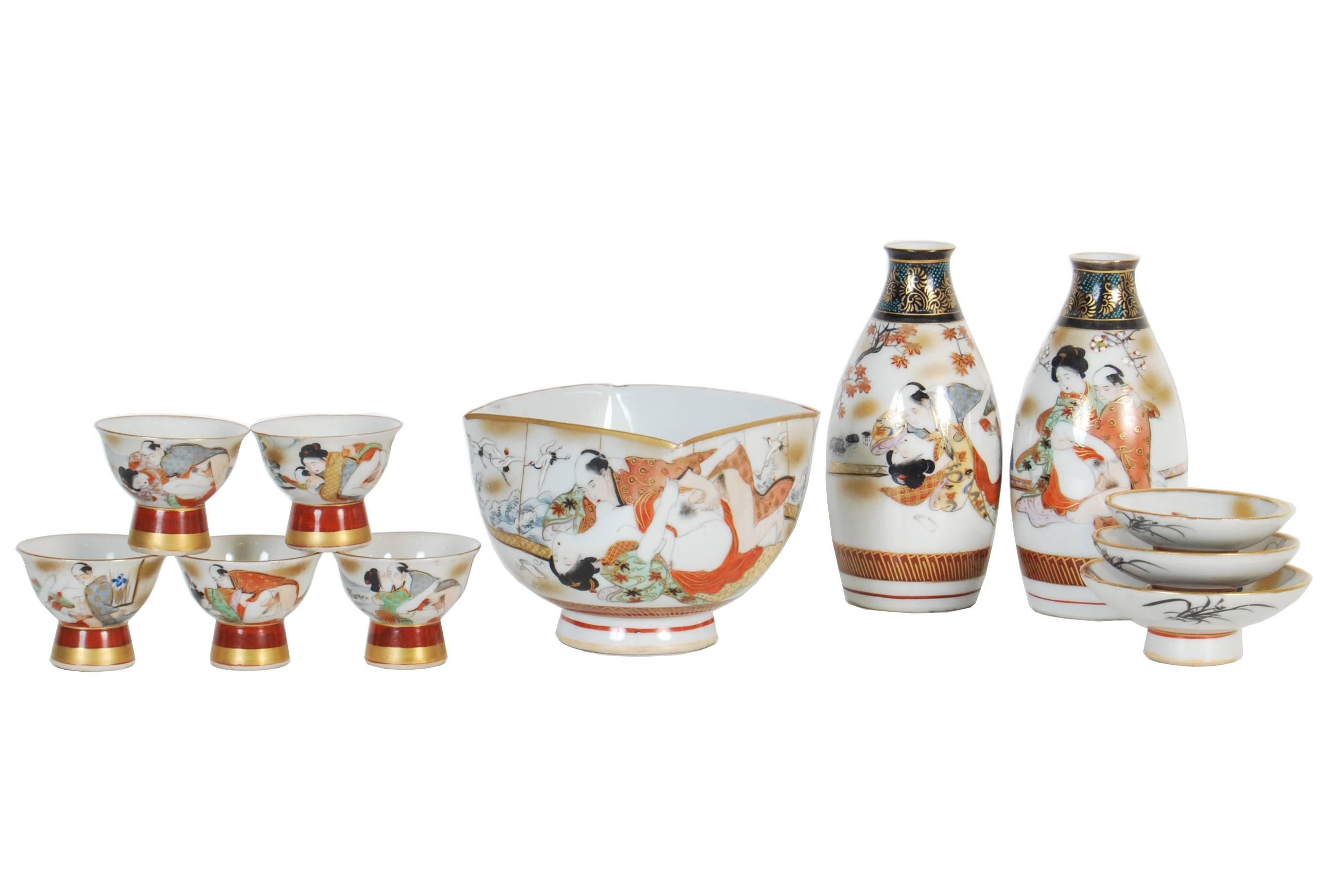 Rare antique Japanese porcelain 11-piece sake set with finely painted shunga erotic scenes highlighted with applied gilding. Meiji period, circa 1890.

Dimensions:

Bottles: H 13.5cm x D 6.5cm.
Haisen (large cup): H 8.5cm x W 10cm x D