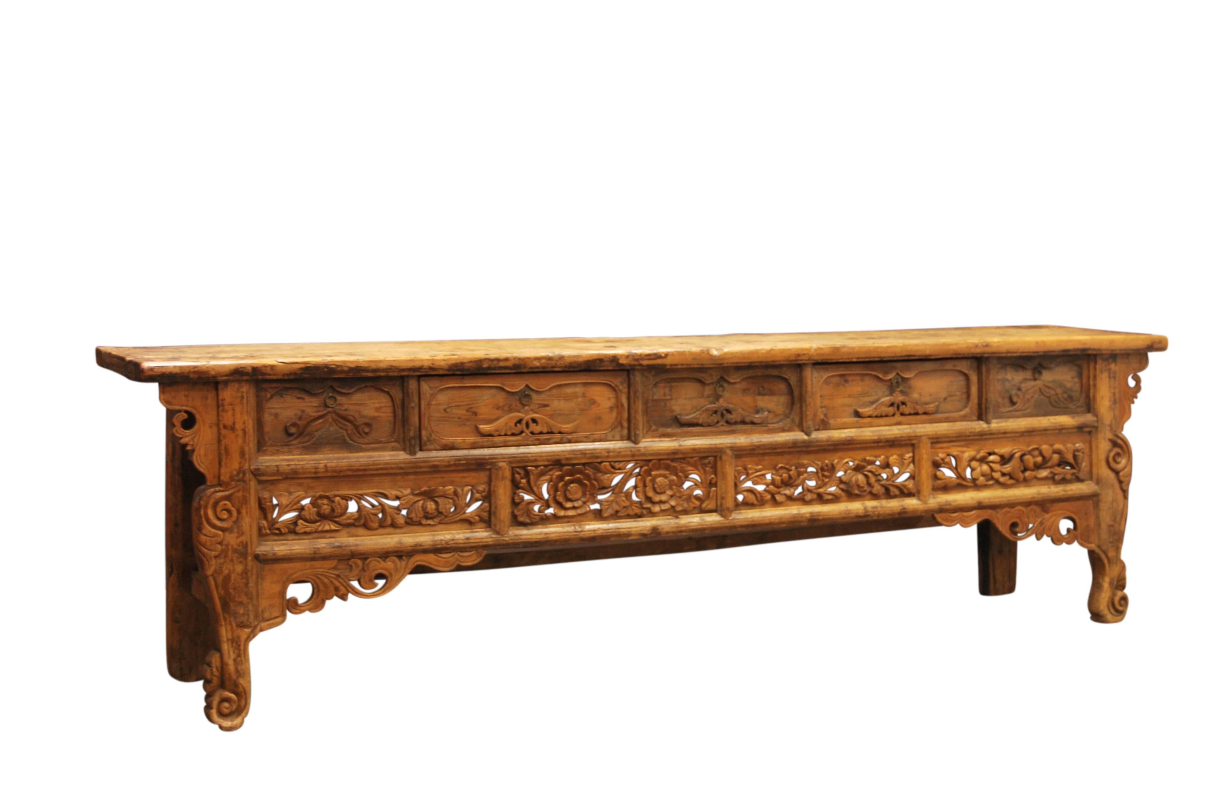 Rare Chinese Buddhist altar table made from bai-mu cypress wood with an elaborate, deeply carved and pierced relief. It also features a floral apron and scroll form feet,. The wood has been worn smooth over time and has a rich warm patina, which has