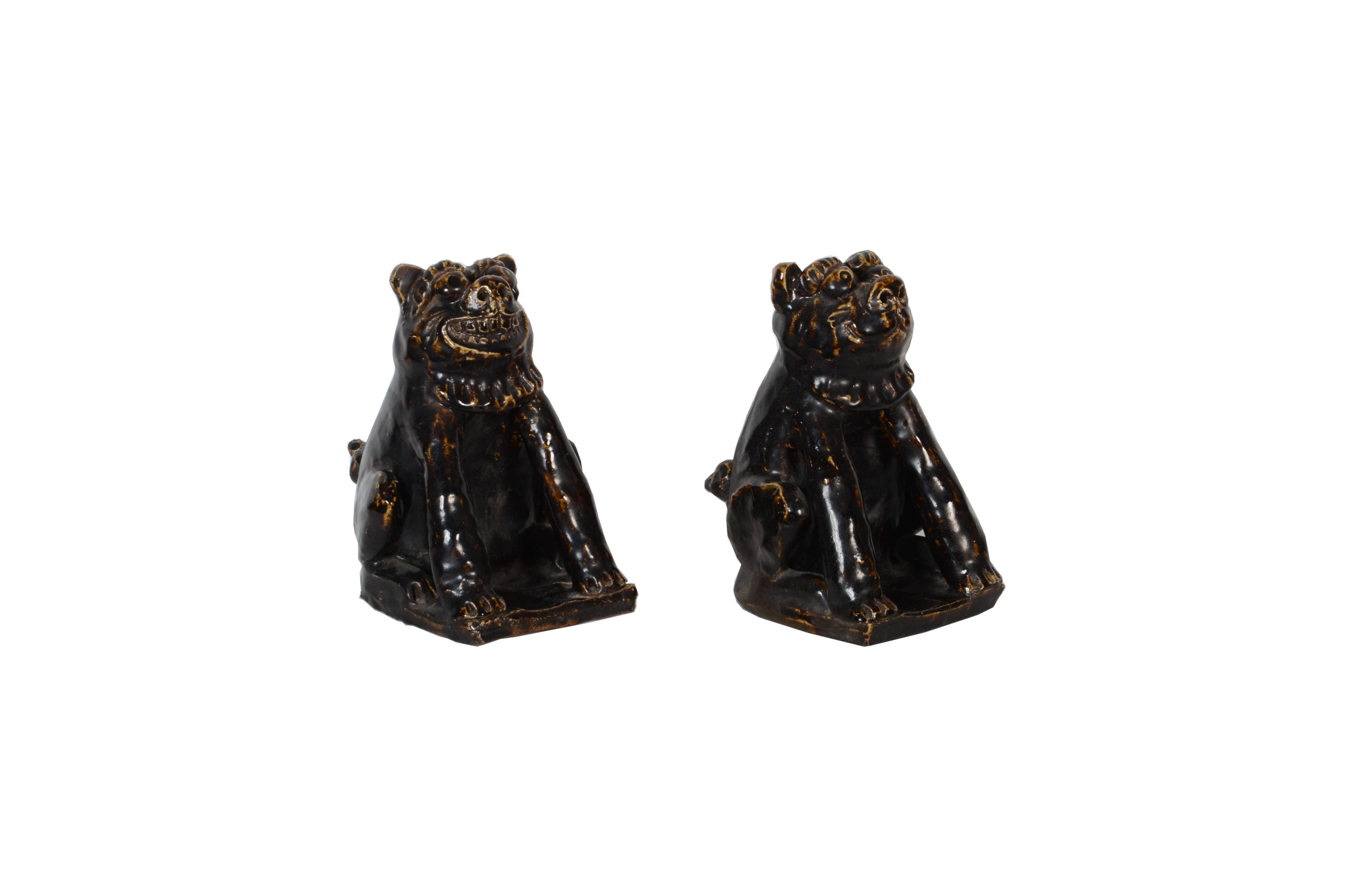 Rare pair of Japanese Folk Art Seto pottery shishi Buddhist guardian dogs glazed in a dark greenish brown toned glaze, late Meiji period

Acknowledged fault: numerous minor firing cracks across surface of both figures, with one large firing crack