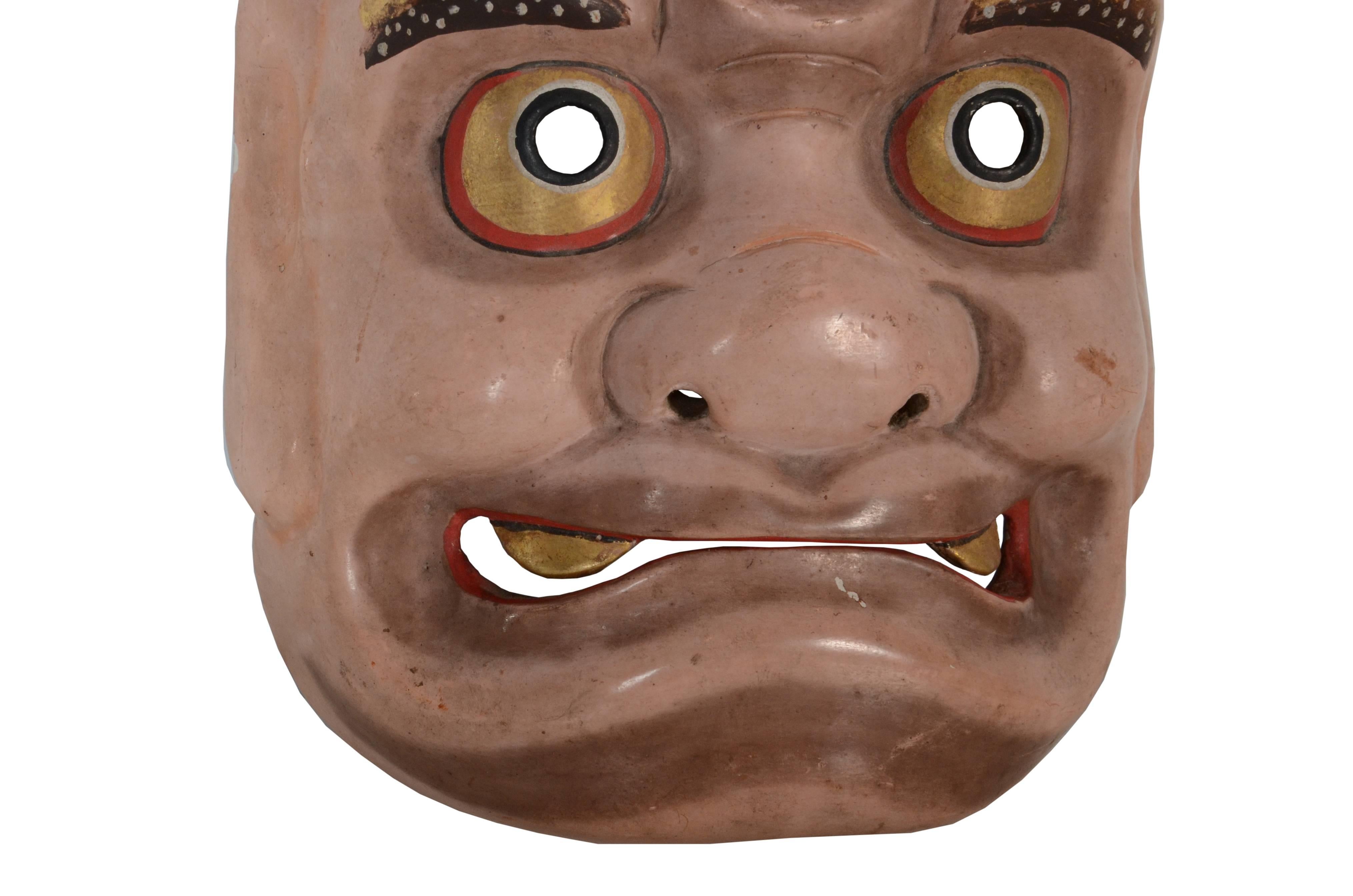 Unusual Japanese Folk Art theatre mask depicting the playful character Mitsumekozo, a three eyed goblin often portrayed as a mischevious creature in comical plays, late Meiji period, circa 1900

Overall the piece is in Fine condition but does have