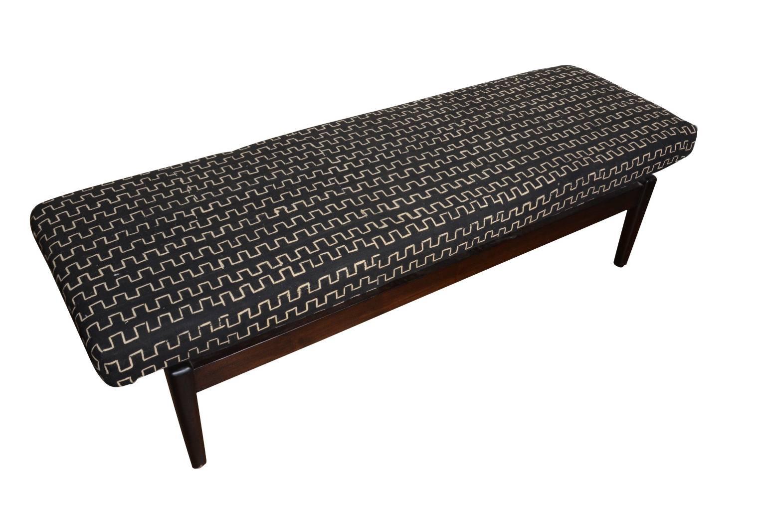 Contemporary bench upholstered in African mudcloth

Materials: Teak frame, mudcloth upholstery.