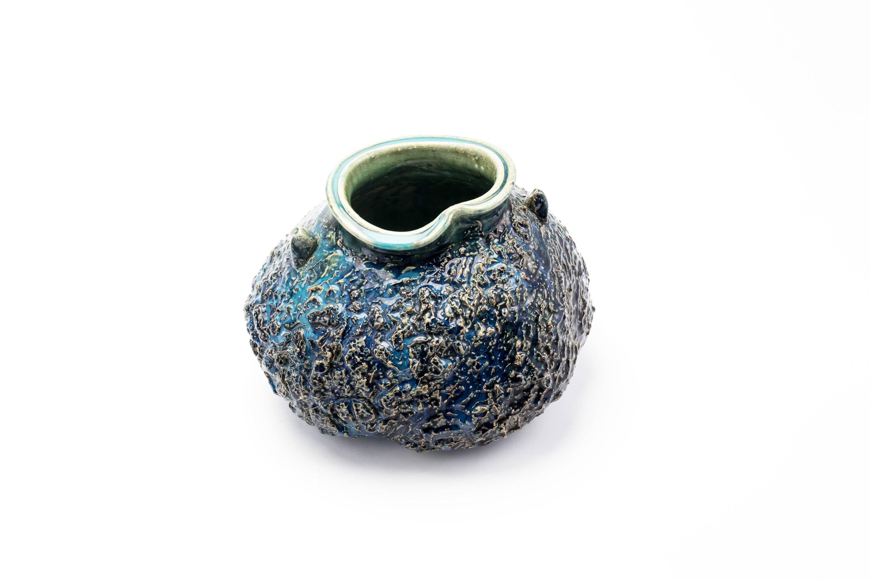 Mid-20th century Japanese Seto pottery vase by Yamaguchi Kozaemon 13th. The vase is hand built in an organic an form with a bright turquoise blue glaze, and high relief rough texture. The artist's signature is etched to the base. Includes the