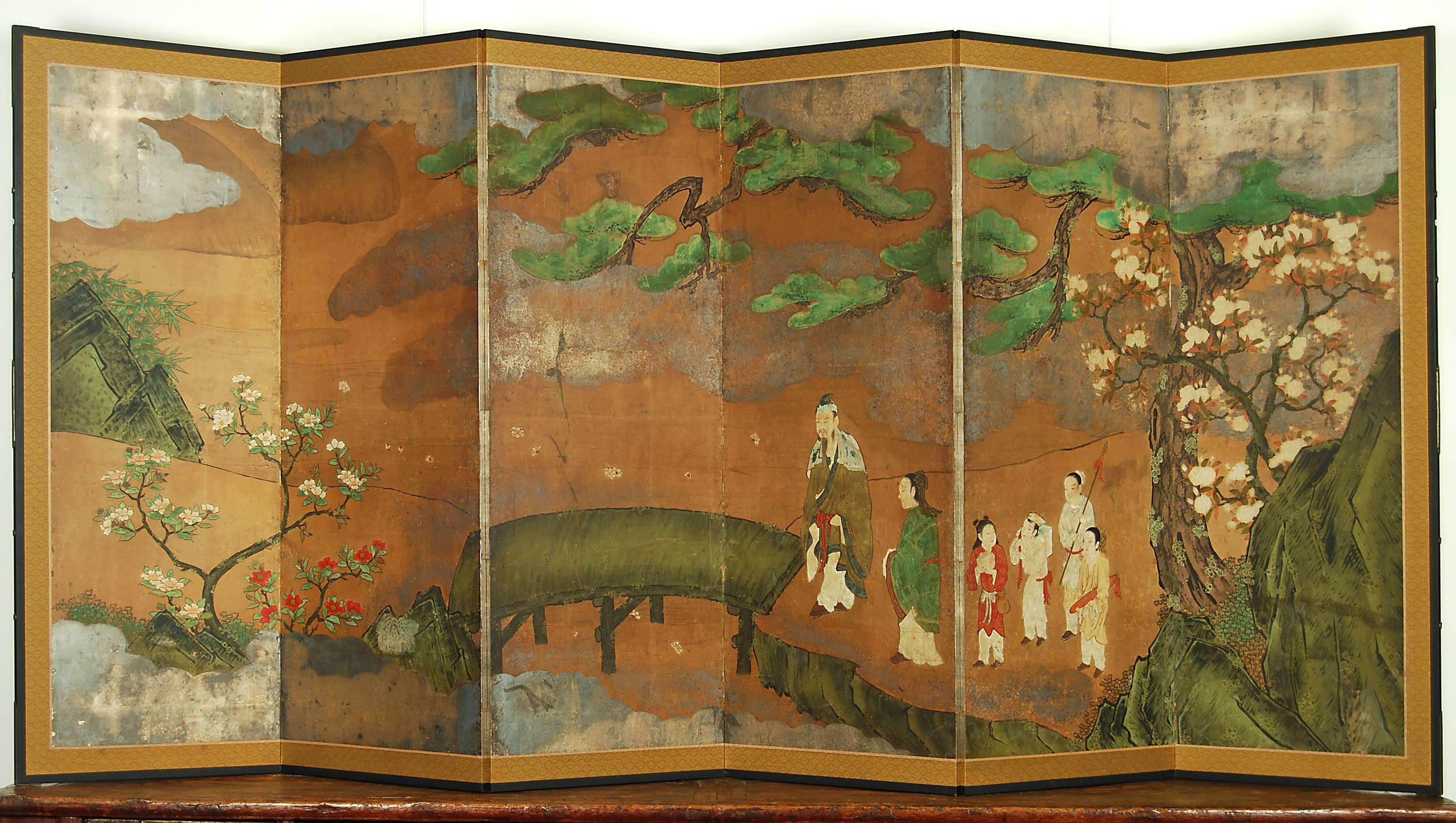 Japanese Kano school screen with pine tree, camellias, cherry blossom and Chinese figures in the landscape, circa 18th century.

Materials: Pigment colors and oxidized silver leaf on paper

Dimensions: H 170cm x W 373cm.