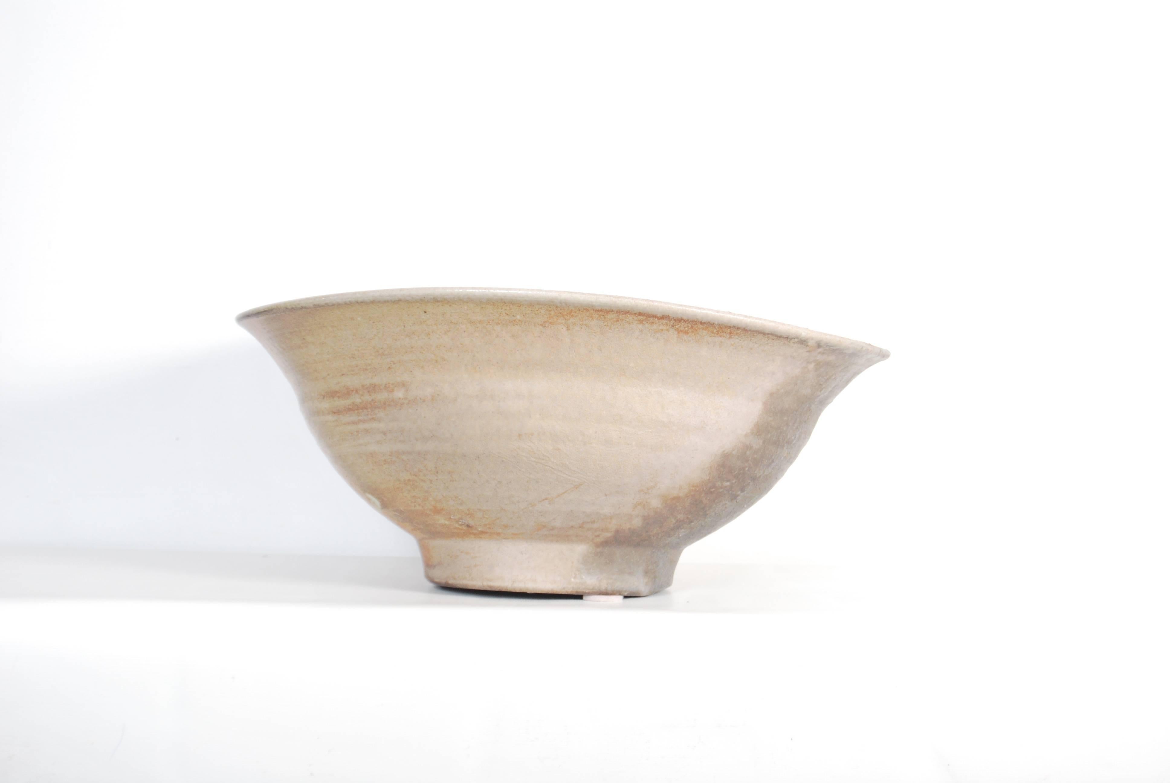 Very large contemporary 'Shigaraki' pottery bowl with an encrusted natural ash glaze by Matsumoto Yoichi. Heavily formed with thick walls tapering to a lightly rolled edge, the piece is finished in variegated of reddish brown with green highlights.