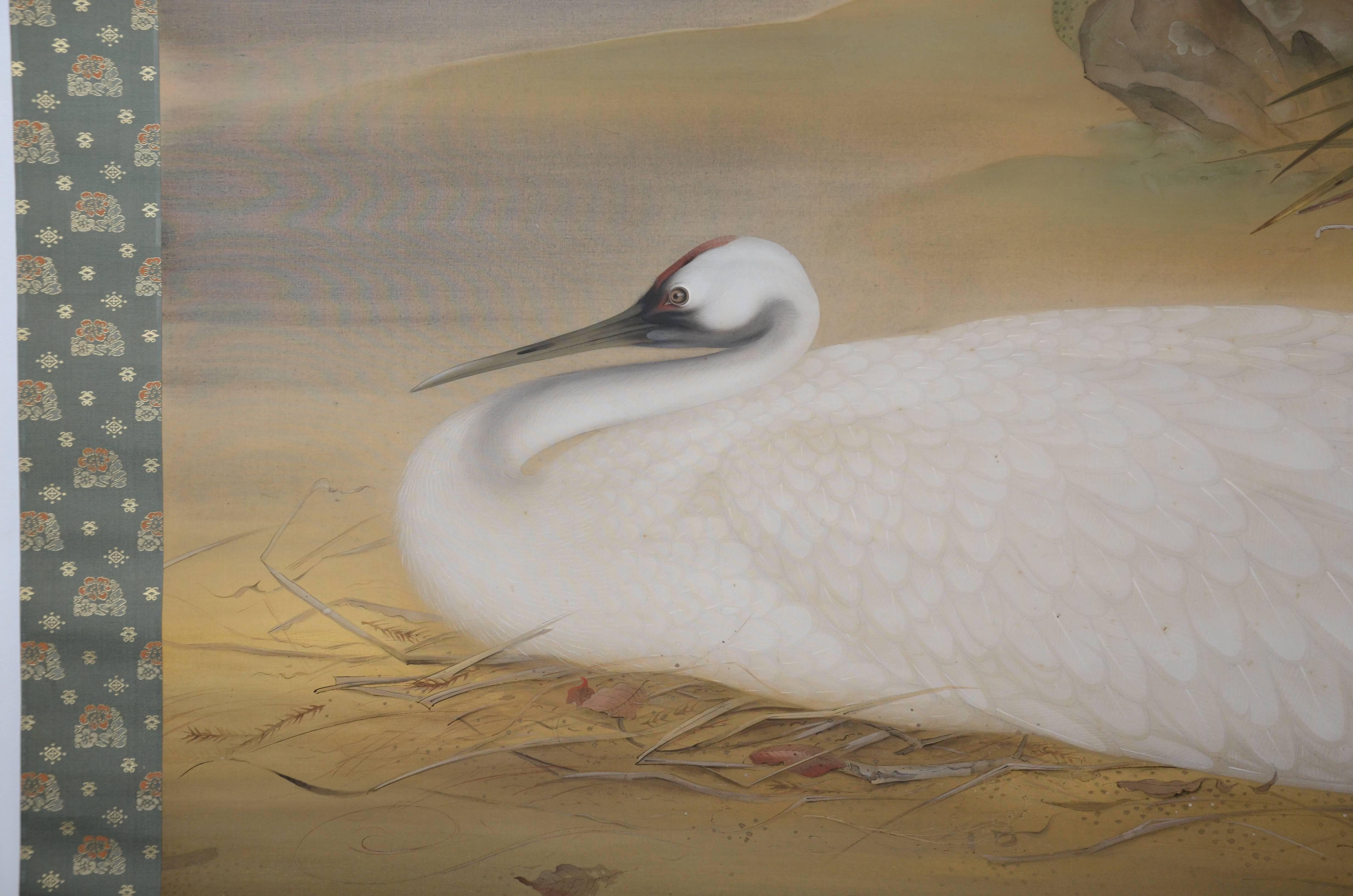 Large and exceptional Japanese hanging scroll with a realistically painted depiction of a nesting crane by Yoshifuji Yoshio, Taisho/Showa period, early 20th century.

Materials: Ink and mineral pigments on silk with brocade mounting fabrics and