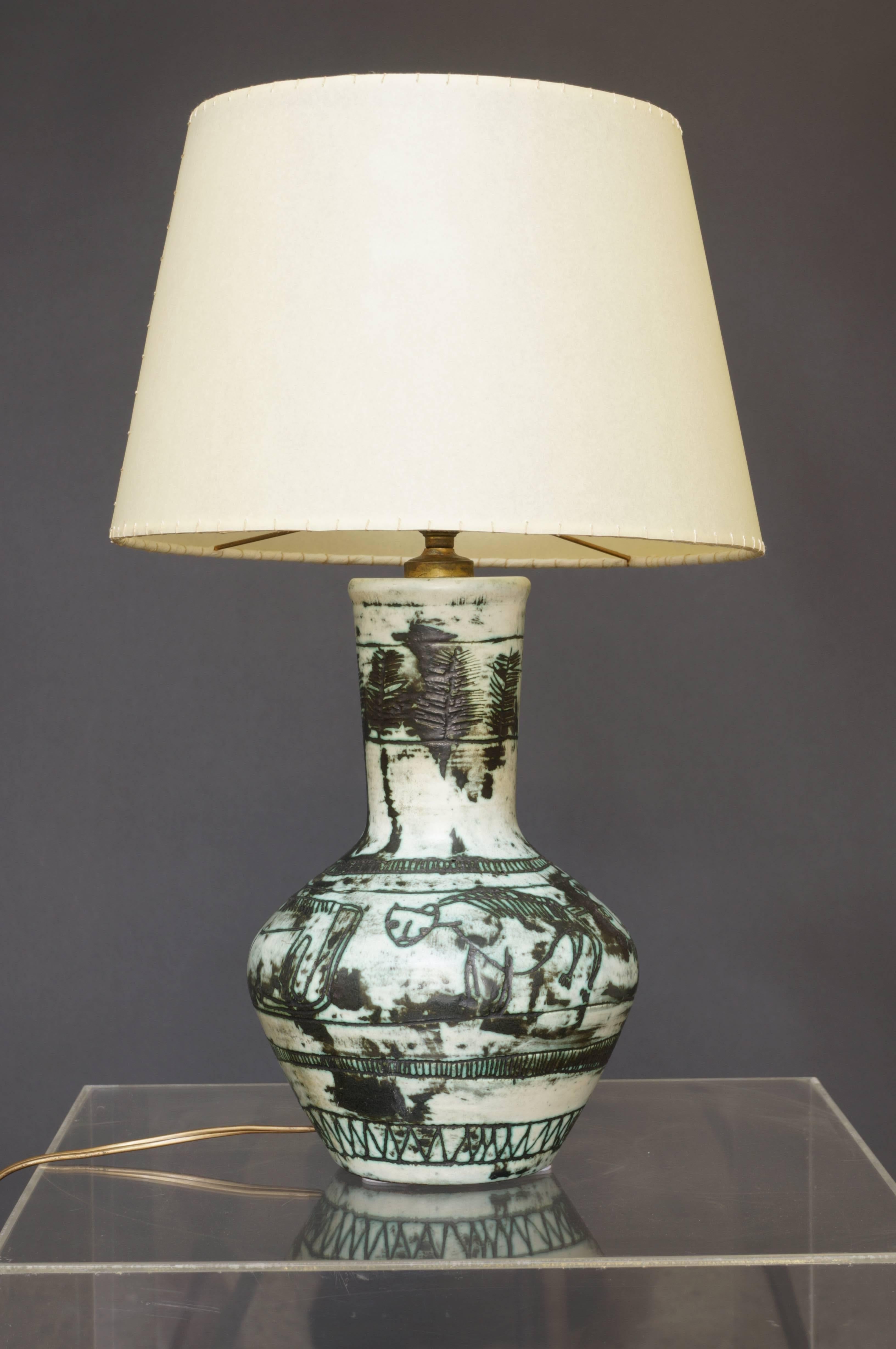 Jacques Blin French ceramic table lamp with green engraved decoration of stylised animals and trees, signed J. Blin, circa 1950.