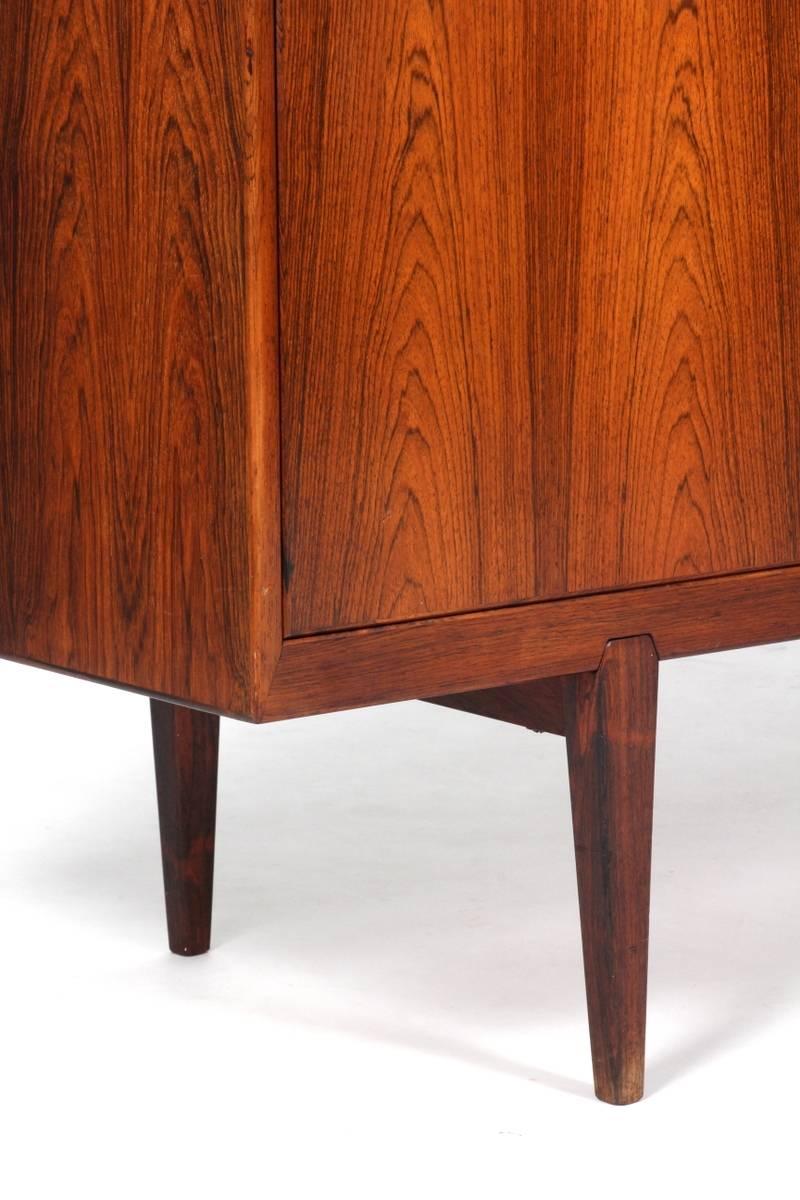 An exceptional rosewood sideboard with four sliding doors. The interior is fitted with dovetail joined drawers. The handles are hand-carved and recessed into the doors. Model 49. Designed by Rosengren Hansen in 1950 produced by Brande Mobelindustri,