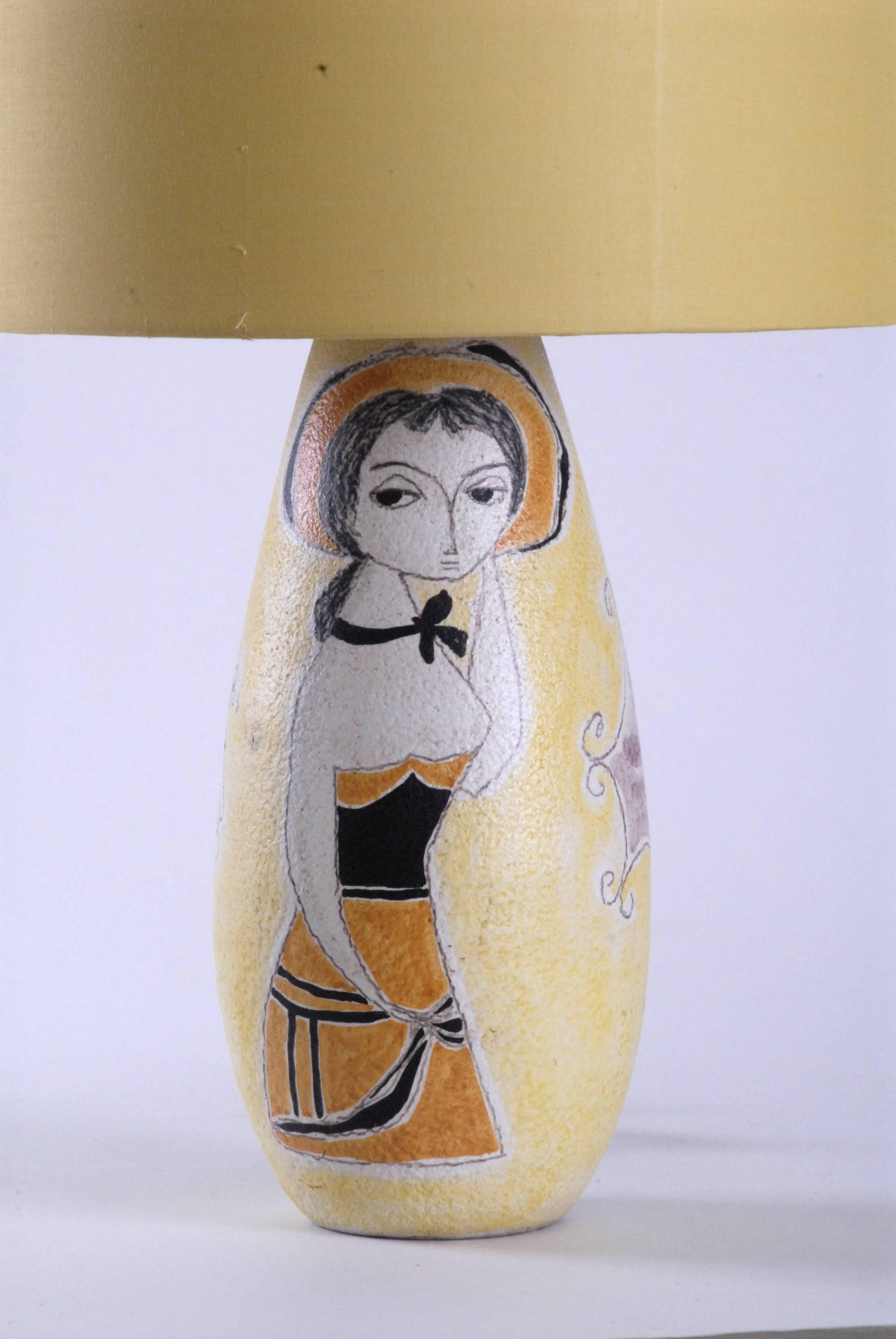 A large Fantoni lampbase in yellow with a single female figure and decorative cartouches and a column to the rear. Italy, circa 1958, marked to the base.