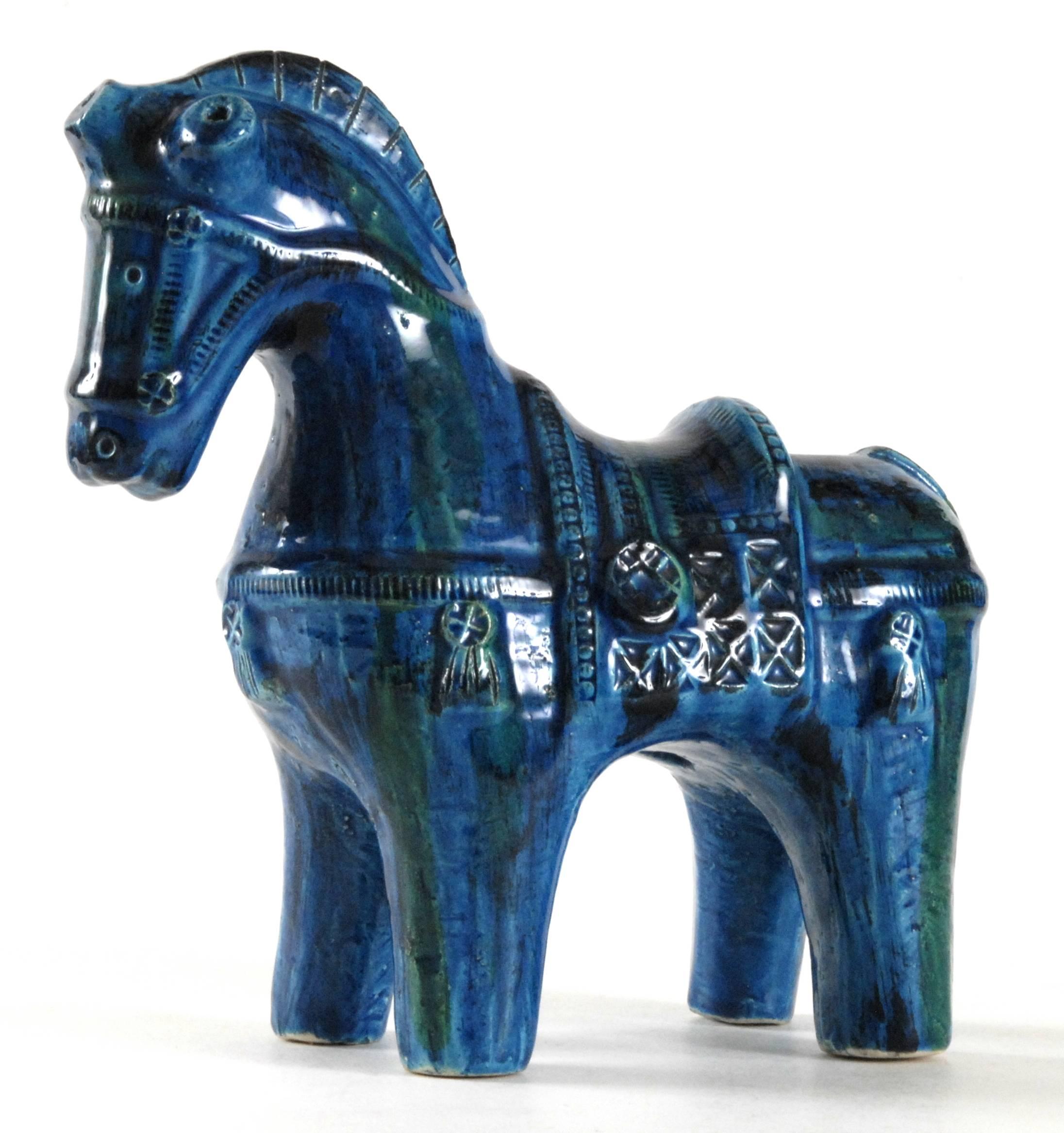 A deep 'Rimini Blu' glazed horse by Aldo Londi for Bitossi. Brilliant glaze with streaks of green over the highly detailed trappings.