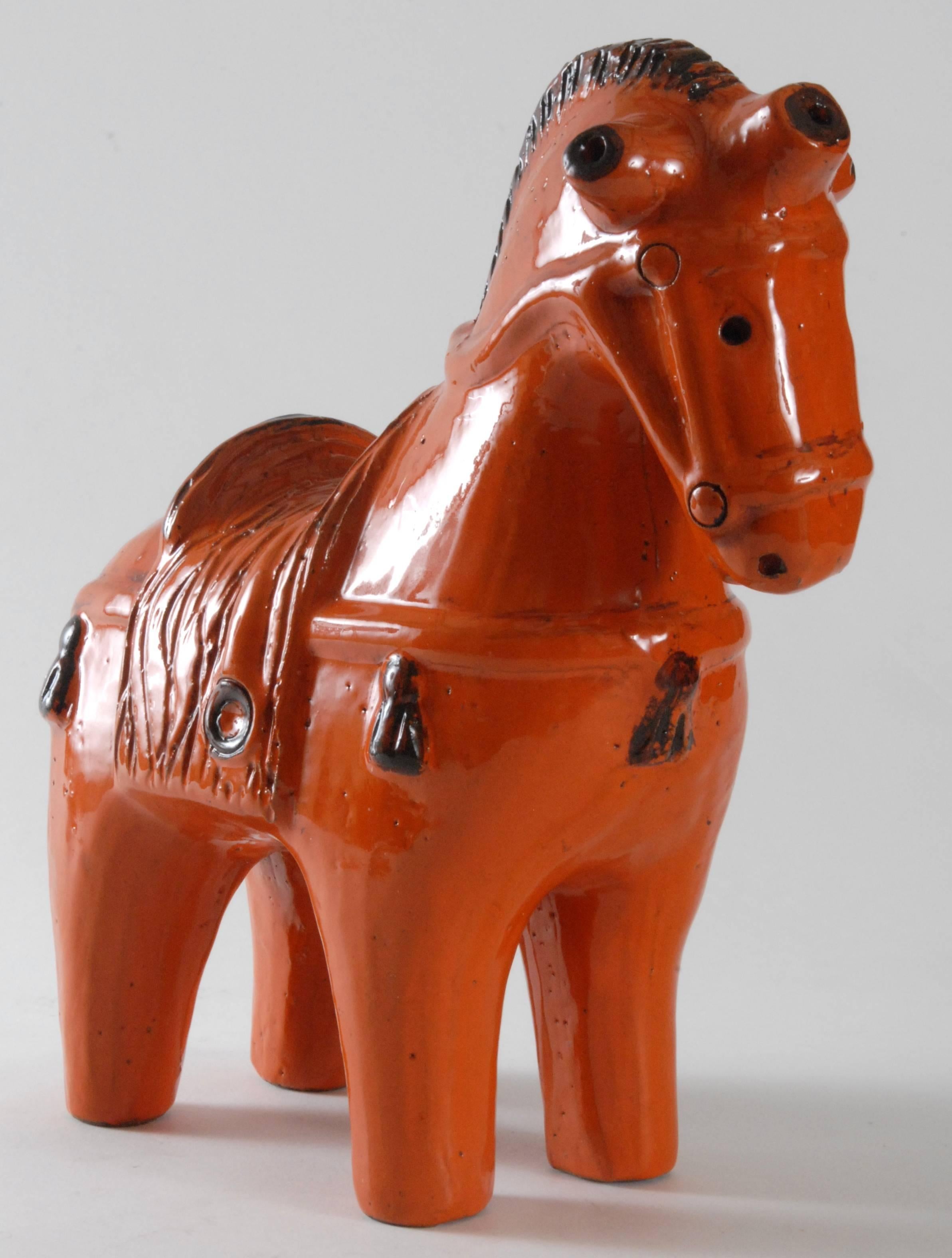 A large Aldo Londi designed brilliant orange horse. Highly stylized, the form resembles ancient clay horses made in ancient Greece, Rome or China. This is the large size at 31 cm high.
