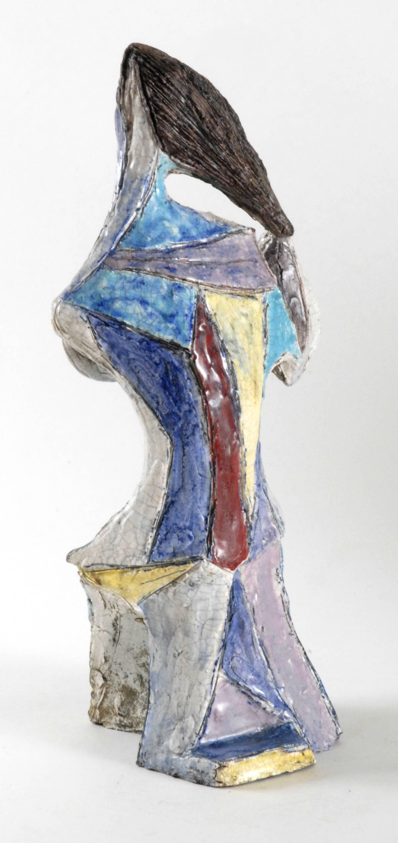An imposing Marcello Fantoni cubist style figure of 'a Woman Brushing Her Hair', c.1954. Built by hand and glazed in pinks, yellow, blue, red, white and black with craquelure glazes. Expensive in their time they are rare today. Two or three very