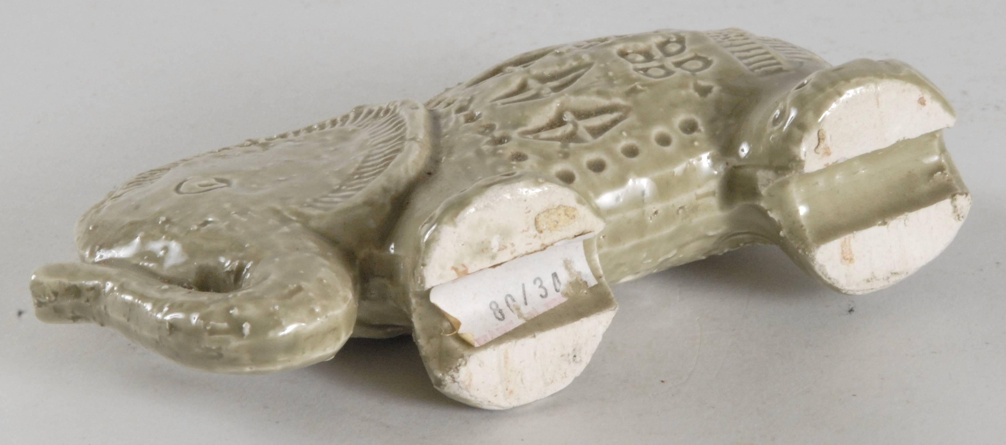 A small quirky elephant from Londi with the 'Rimini' pattern in a pale green glaze.