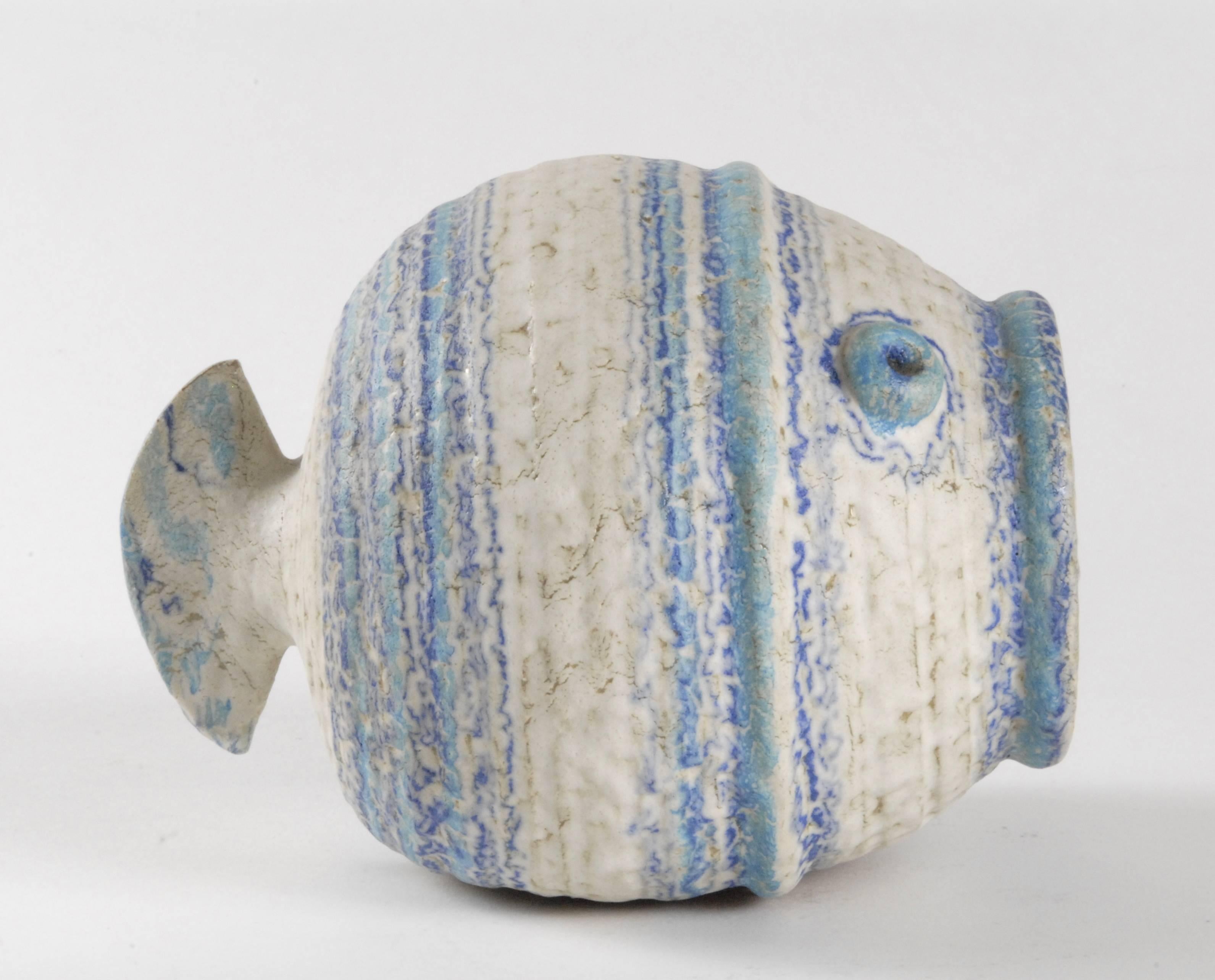 An Aldo Londi designed globular fish in matte off-white, royal blue and turquoise glazes with a mottled effect.