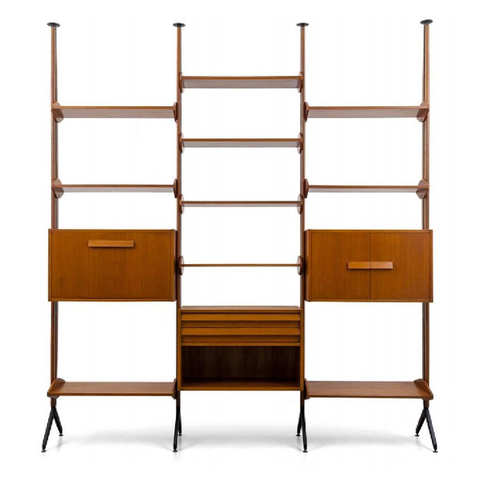 An architectural shelving system or room divider in teak and lacquered metal.  Italy 1960s.

The shelving comprises four uprights - which can be configured as two single bays, a double or triple - together with three cabinets and ten shelves.  The