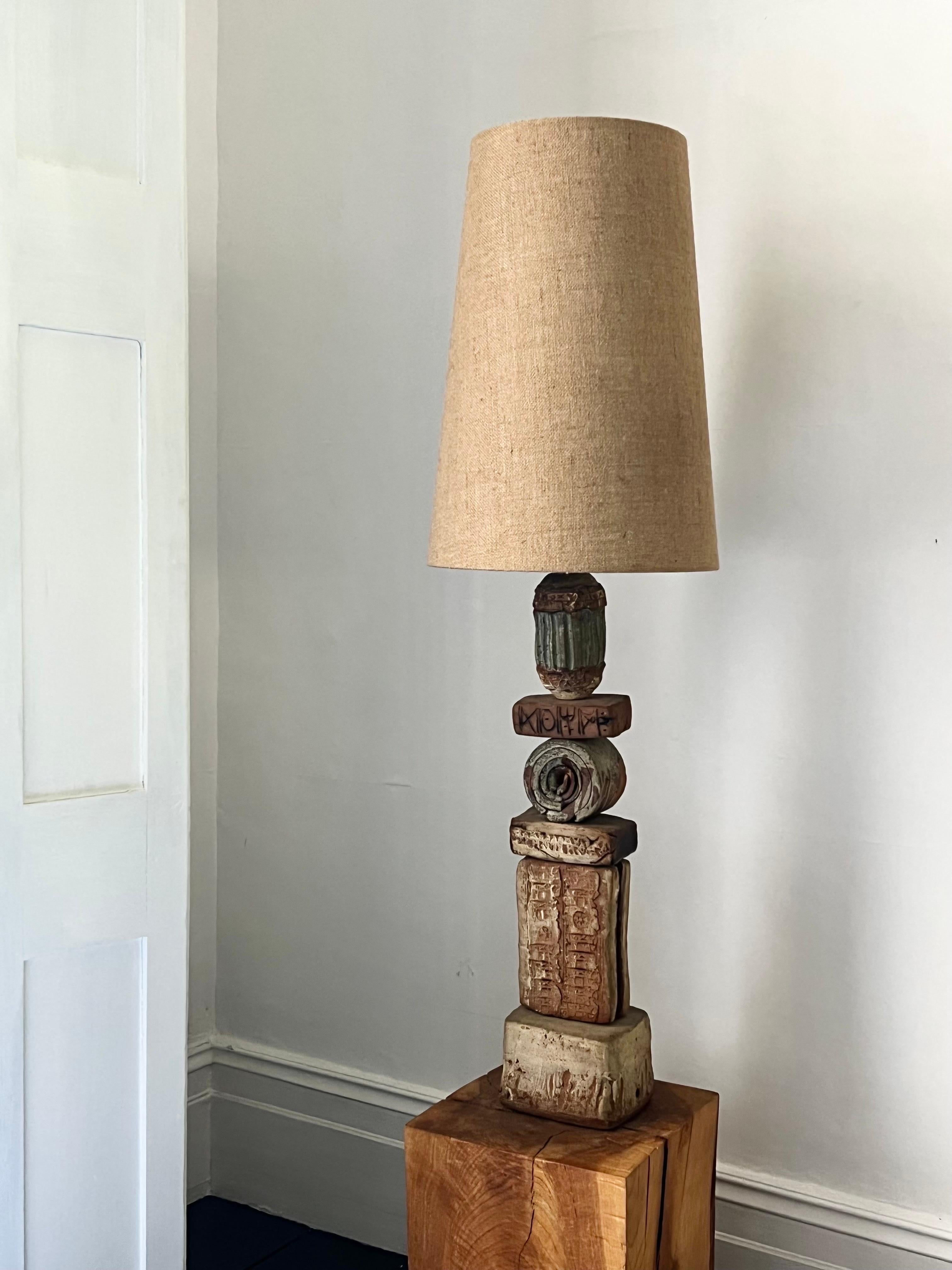 A large, or oversize, ceramic TOTEM table lamp by Bernard Rooke, England. 

This design is an early example of Rooke's work, probably 1960s. A sculptural piece, made of hand-made ceramic elements in natural tones of terracotta and stone, with a