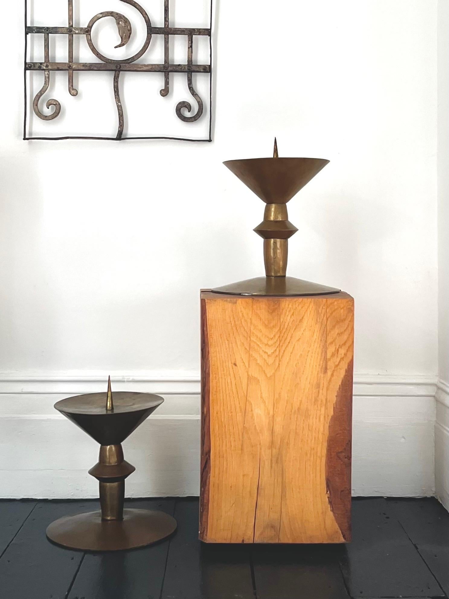 A pair of impressive brass candleholders, former church pieces, in art deco style. 20th century, found in Germany.

The pieces are made of sheet brass, which has been hammered. They are in fair vintage condition with a nice mellow patina. There are