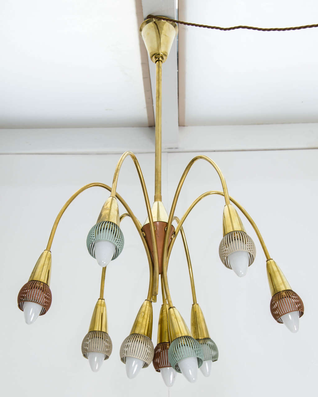 A delicate midcentury chandelier with brass frames and painted cage details, in the style of Stilnovo, Italy. Two available, price per piece.

Each piece has nine lights; the chandeliers are fully rewired and certified for the UK (PAT