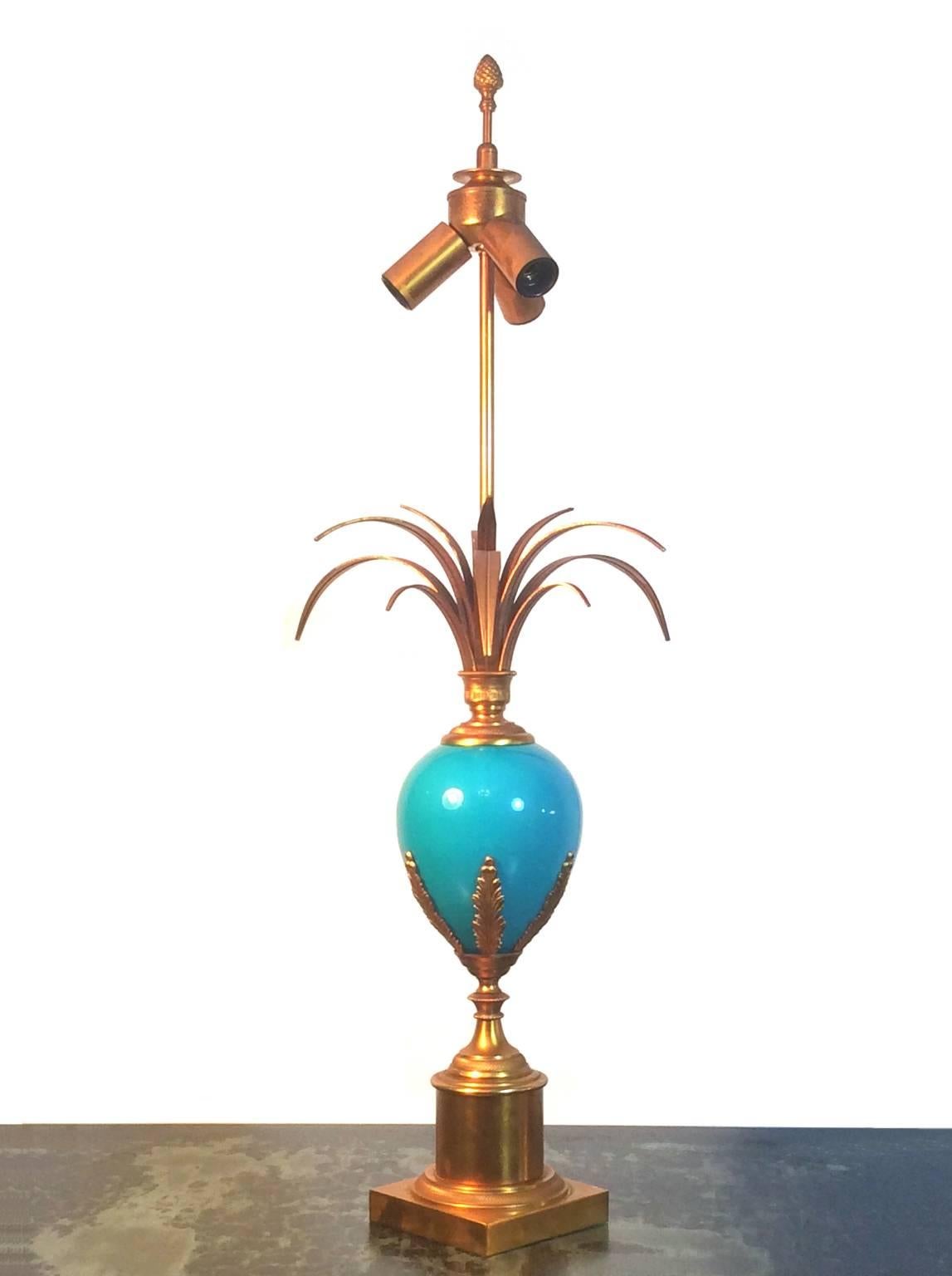 Table lamp with blue glass egg and gilt brass body. Very much in the style of Maison Charles, France, 1960s or 1970s.

Nice original condition with minor signs of wear in line with age and use, and an overall aged patina to the gilt brass. Due to