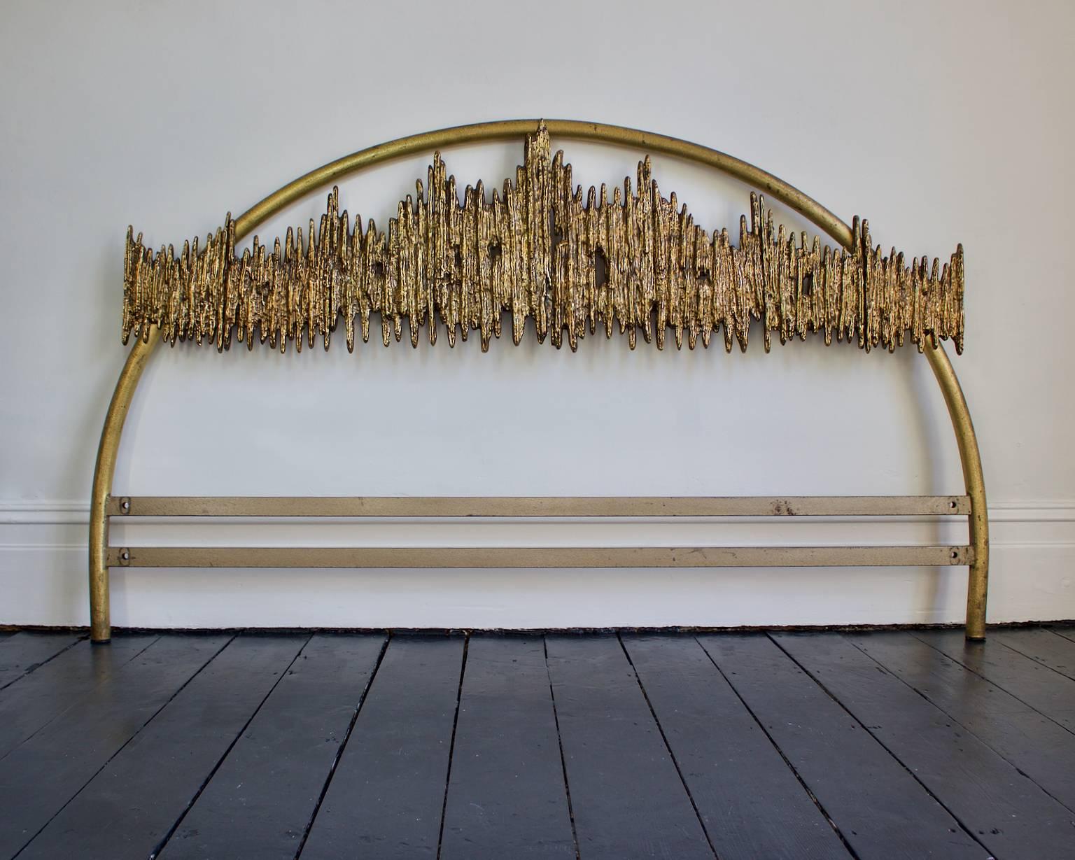 Headboard with large brutalist bronze sculpture by Frigerio, Italy, 1960s.

The headboard comprises an arc of lacquered steel (deep gold in colour) overlaid with a large brutalist sandcast sculpture. The sculpture is bolted to the bed frame; it