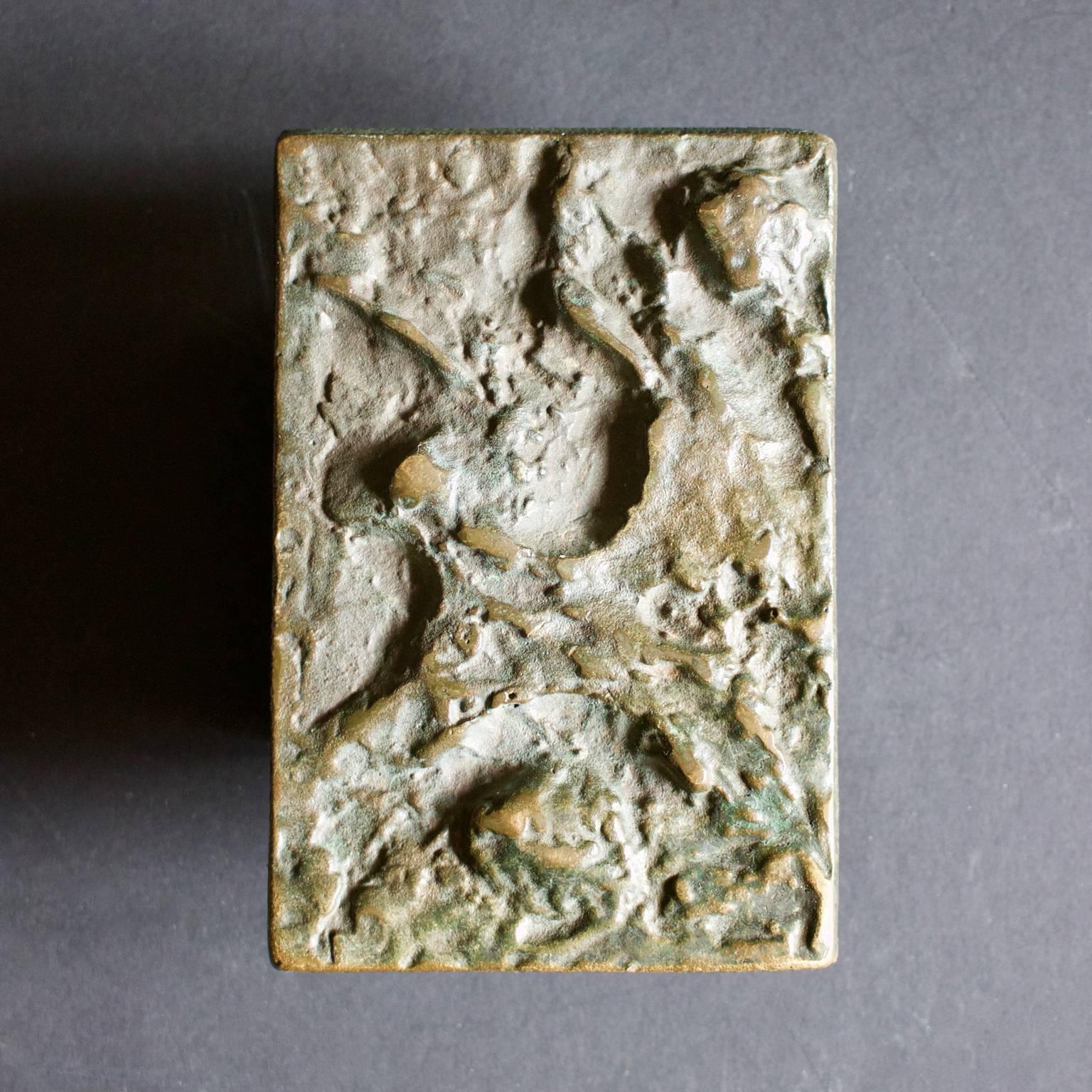 A single rectangular bronze door handle with abstract relief, evoking the textures and patterns of natural rock. Europe, mid-20th century.

The handle is in good original condition, and there are minor signs of old paint on the reverse which cannot