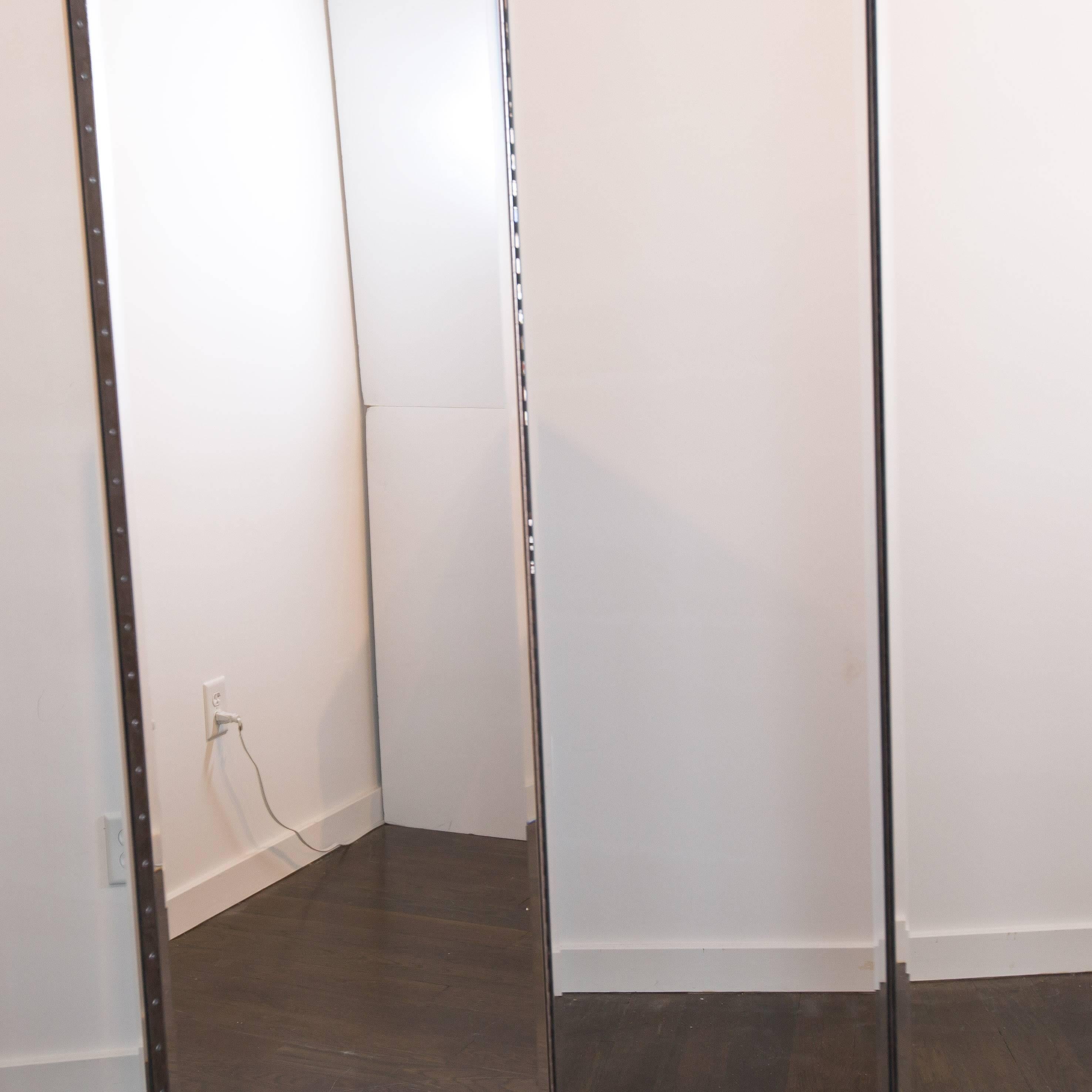 Clean, well-constructed screen with beveled mirror panels on front side and left and right edges. White laminate on back side. 