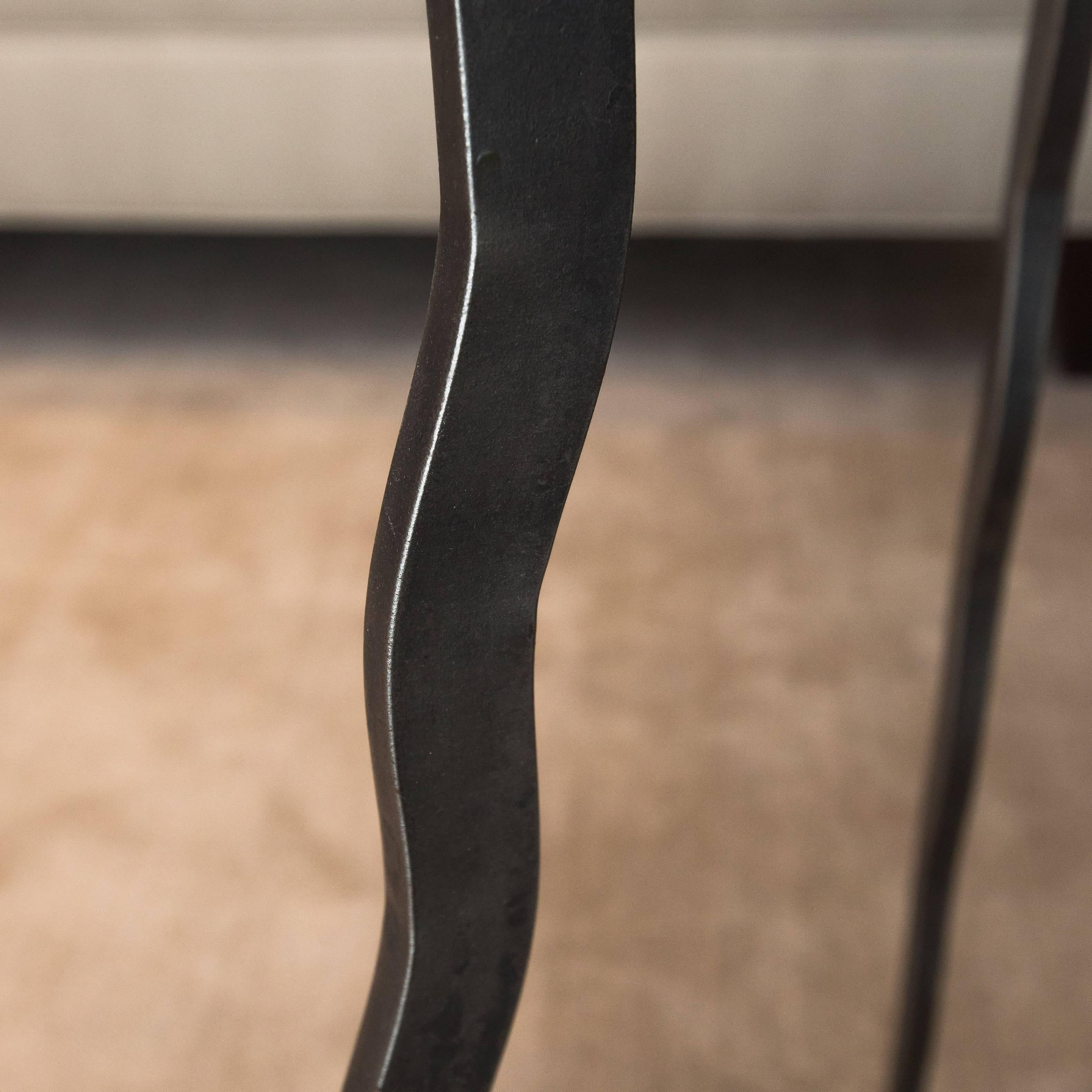 Three-legged hand-forged steel table with glass insert by NYC artist Will Stone.