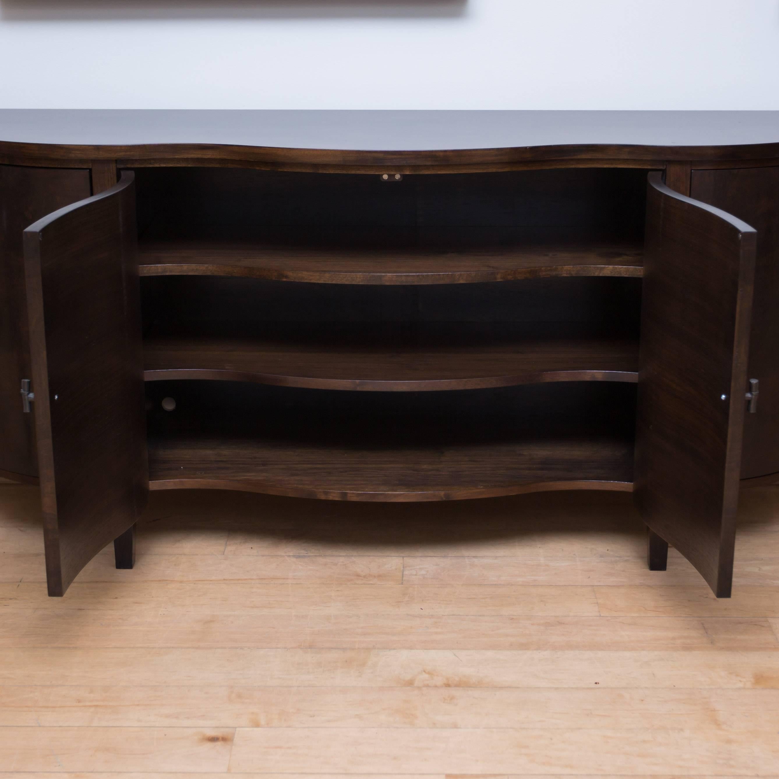 A whole new take on the classic server/sideboard. This curved front buffet with its beautifully bookmatched burl walnut veneers and pewter pulls is a custom piece that will reflect well on its new owner's one-of-a-kind taste.