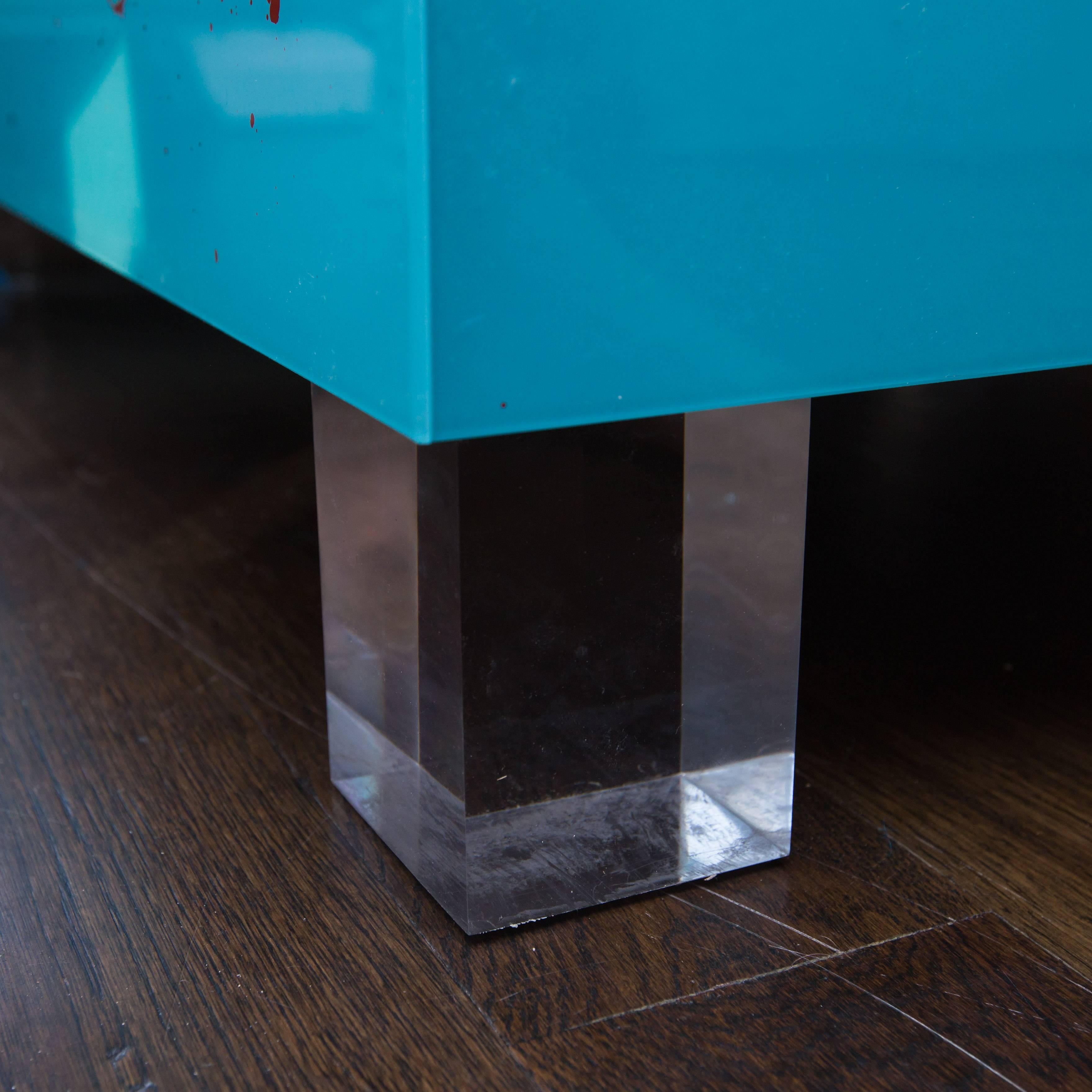Custom, one-of-a-kind coffee table made of reverse drip-painted Lucite panels sitting on solid Lucite feet.