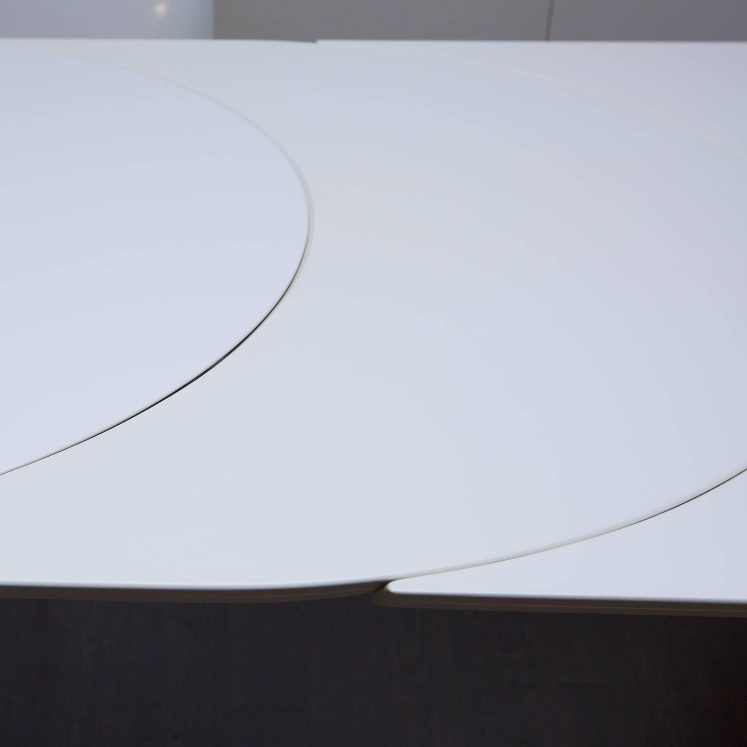This is a really cool designed extension table by Roger Rougier consisting of a round pedestal base and curved end that rides on castors so table can move sideways with ease. Using the crescent shaped leaf the table extends an additional 18 inches.