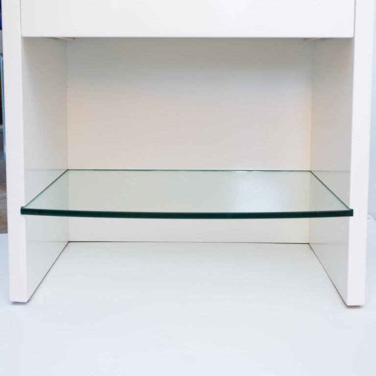 Pair Of White Lacquered Nightstands With Floating Glass Shelves At American Modern Pair Of White Lacquered Nightstands With Floating Glass Shelves For