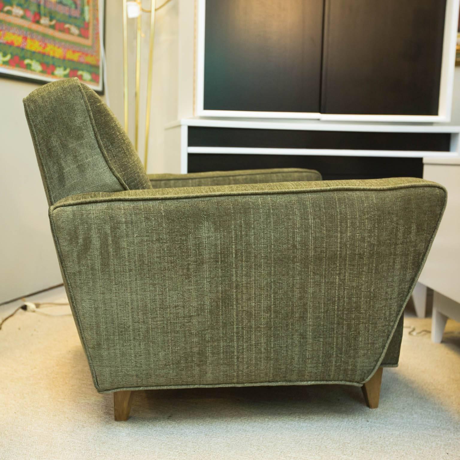 Classic late 1950s-early 1960s lounge chair professionally reupholstered in a light sage green velvet with blonde mahogany legs.