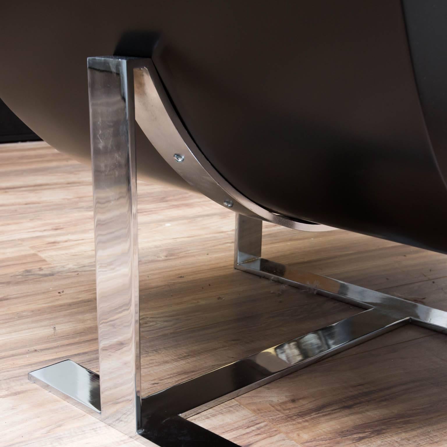 Reminiscent of Jay Spectre's Eclipse series of chairs, these chairs feature heavy chrome-plated legs and black lacquered wooden frames.

35 in.Hx26 in.Wx34 in.D.