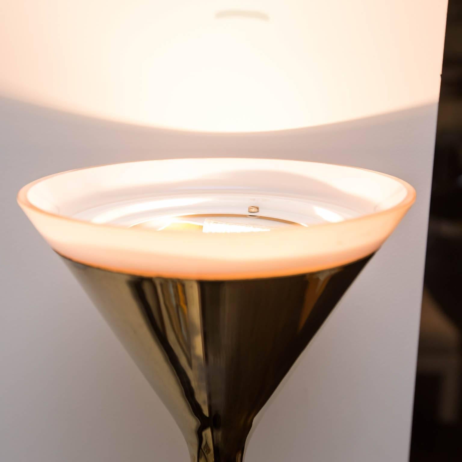 Reminiscent of Sonneman's lamps, but have I've never seen another one like this, with this elongated hourglass shape. Cast-aluminum with heavy brass plating that really shines and a cast iron form fitted weighted base. Rim of milk glass at top.