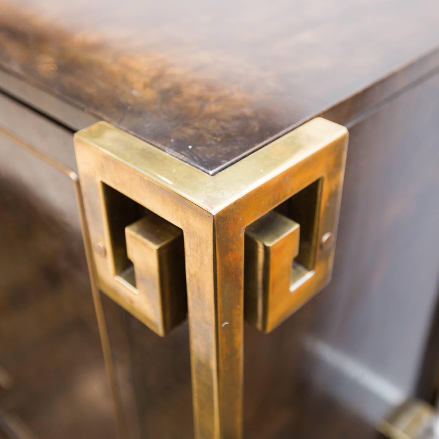 Dramatic Greek-key themed design by Rohne for Mastercraft. Beautiful burled walnut veneers and brass hardware and trim make this a great anchor piece for any room.