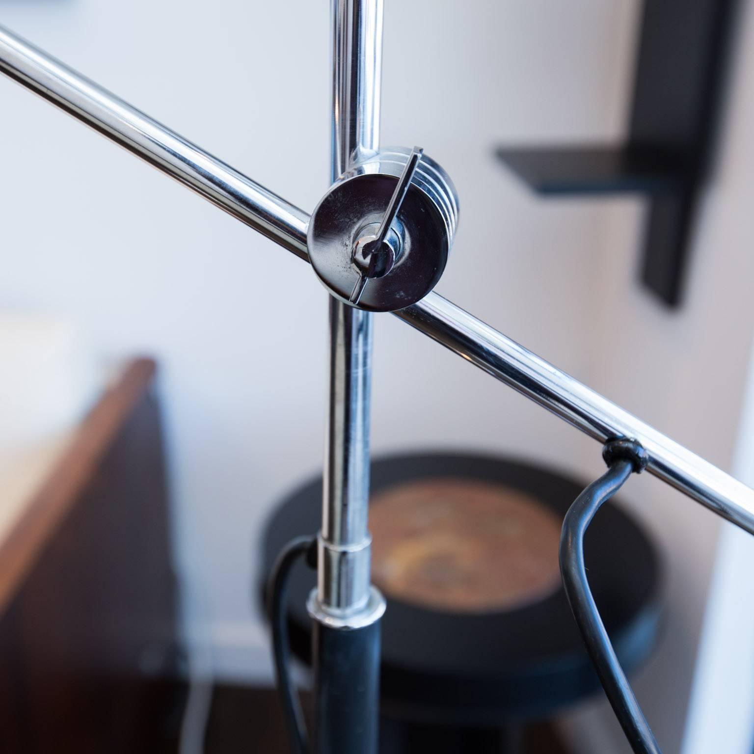 A modern, heavier and higher quality version of the Sonneman or Kovacs orbiter lamp. Black leather-wrapped counter balance and black painted column with chrome arms and tri-leg base.