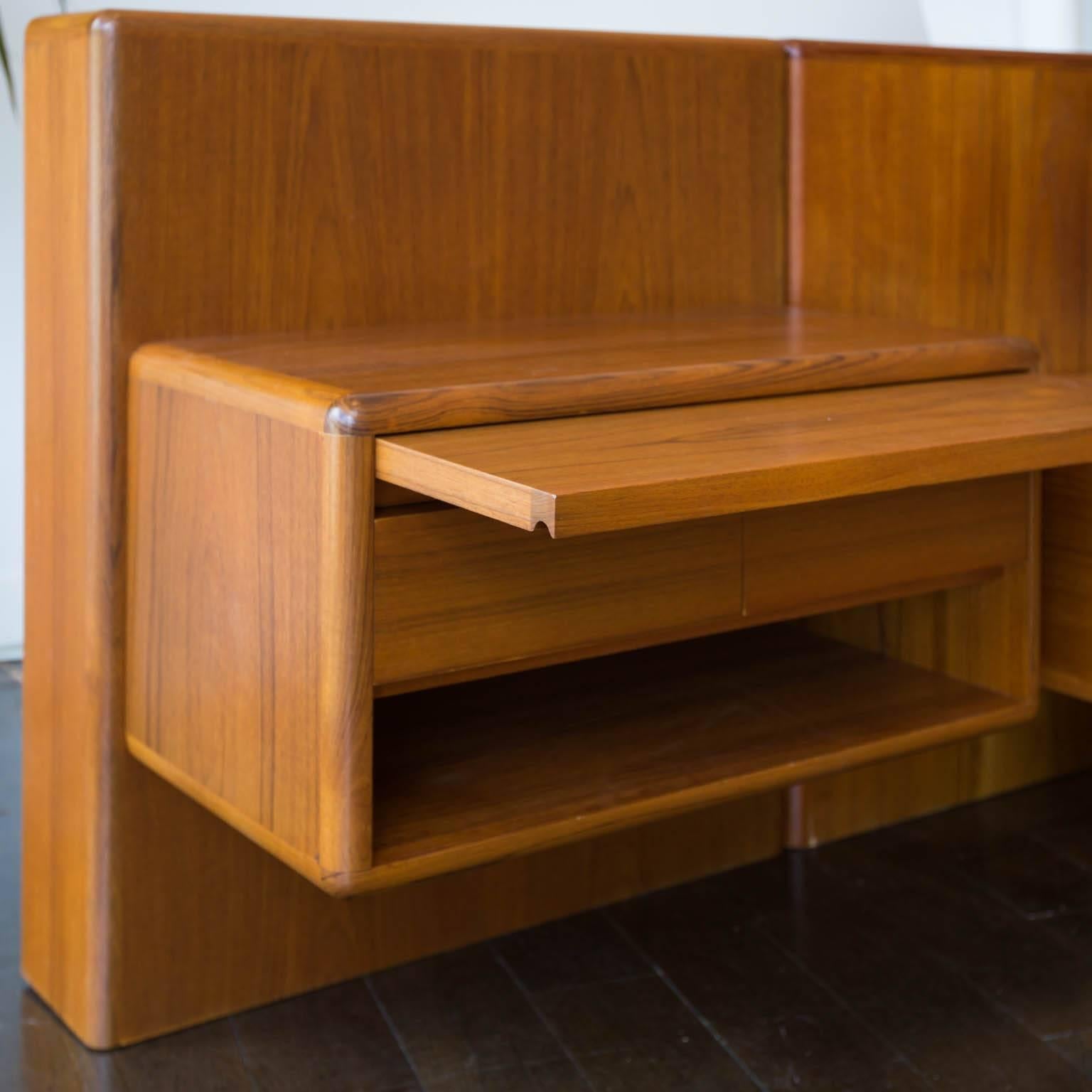 One of the better versions of 1970s era teak platform beds with floating nightstands, this piece features a sliding drink shelf and two drawers per side. Refinished and ready for your mattress.