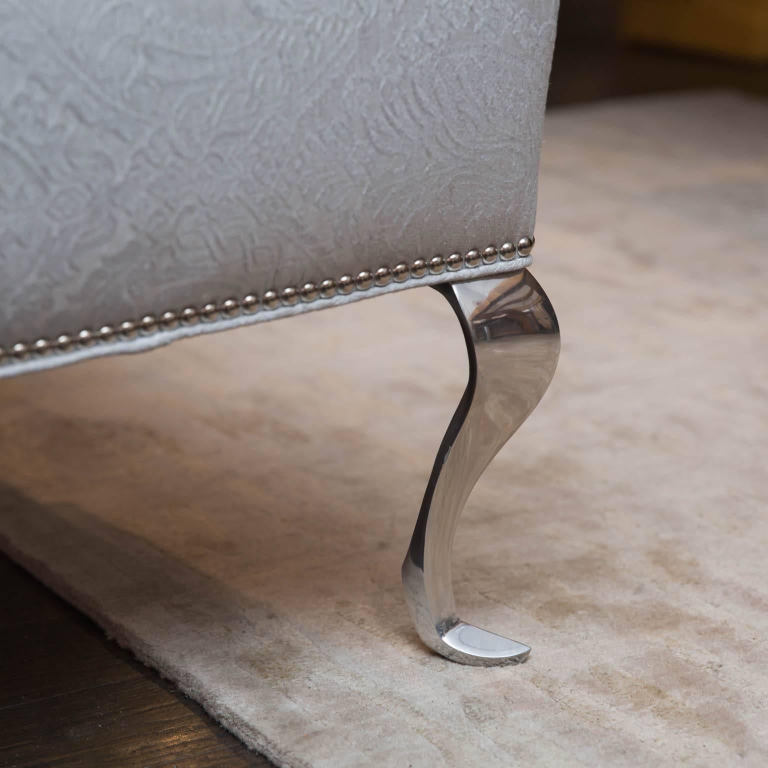 Beautiful custom-made upholstered bench with nailhead trim and polished cast-aluminum legs.