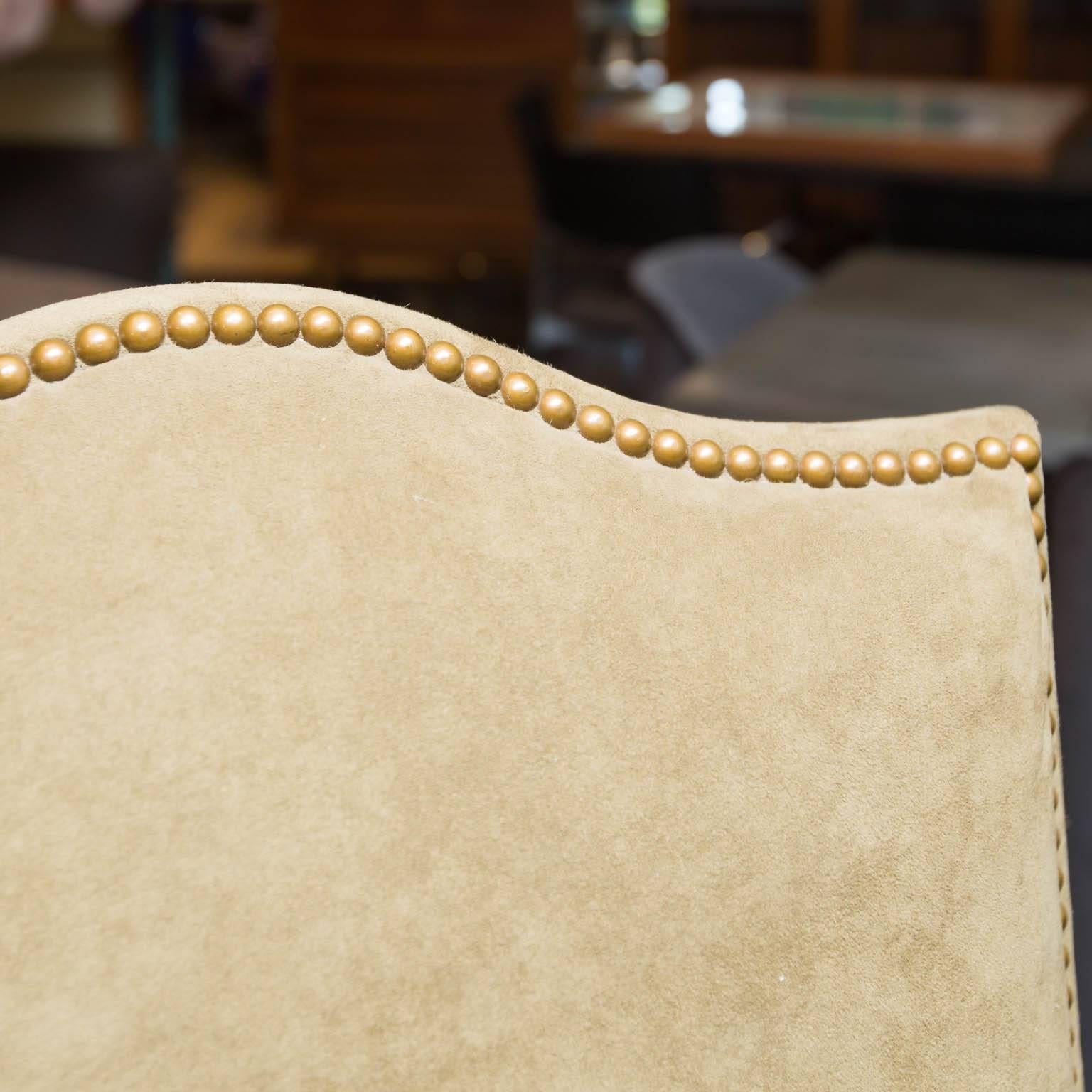 Upholstered in a khaki and olive green ultra-suede with faux snakeskin Naugahyde seats and nail head trim. Includes two arms and eight sides. Side chairs are slightly less wide at 21.5