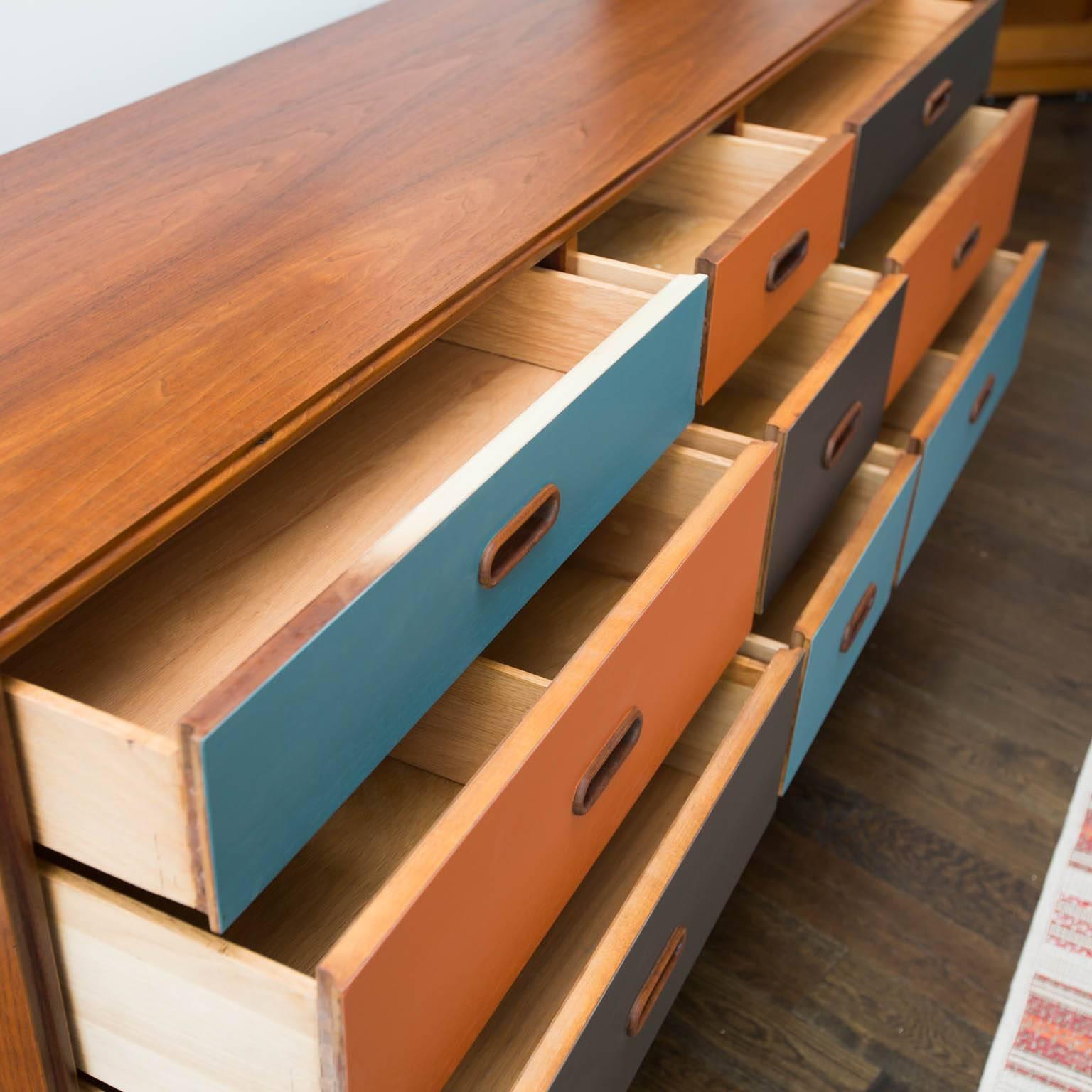 A nice tweaking of a vintage Danish modern Classic. Teak construction with lacquered drawer fronts.