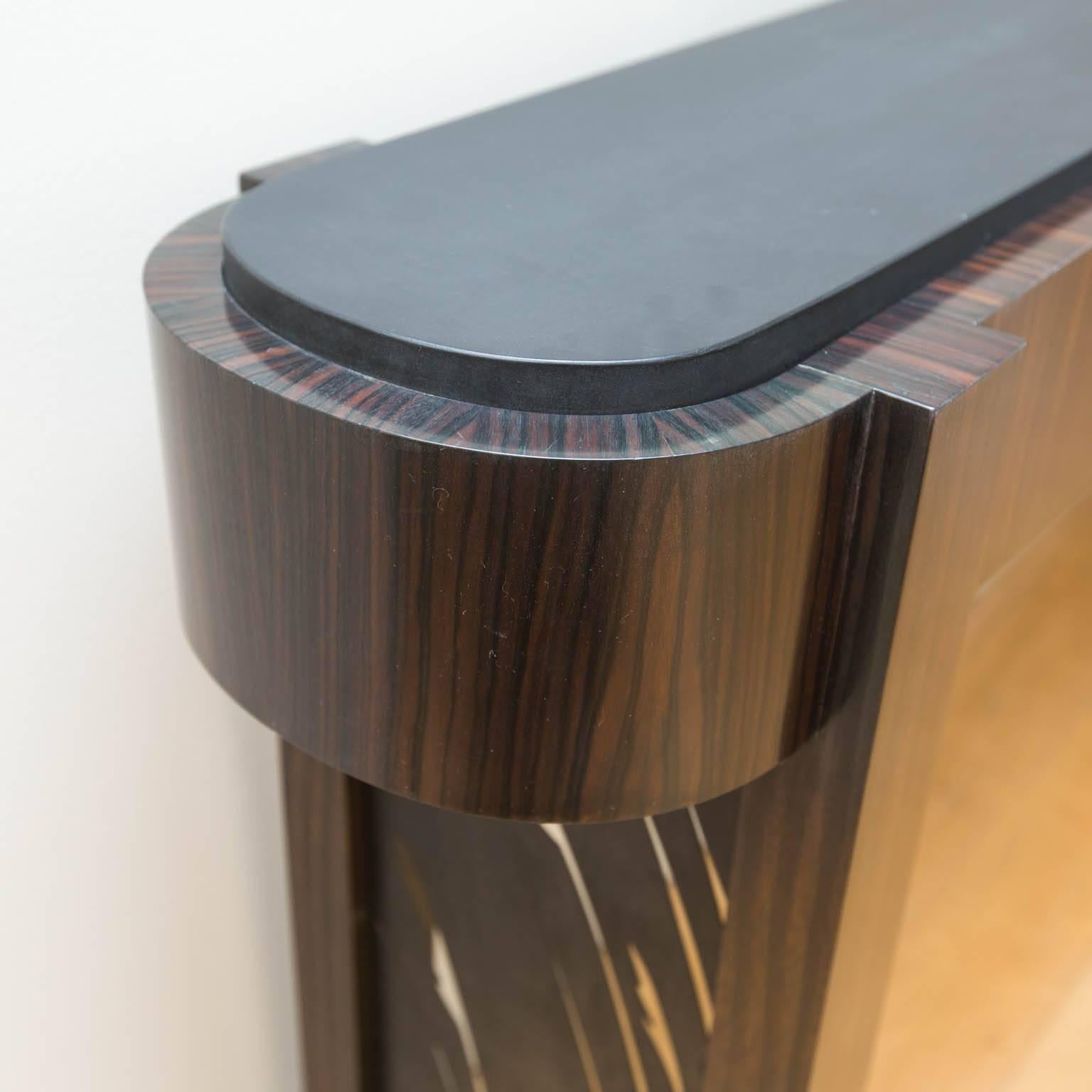 Black granite topped with Macassar ebony veneers and laser cut patinated steel insets. Handcrafted by master furniture maker Gregory Clark.