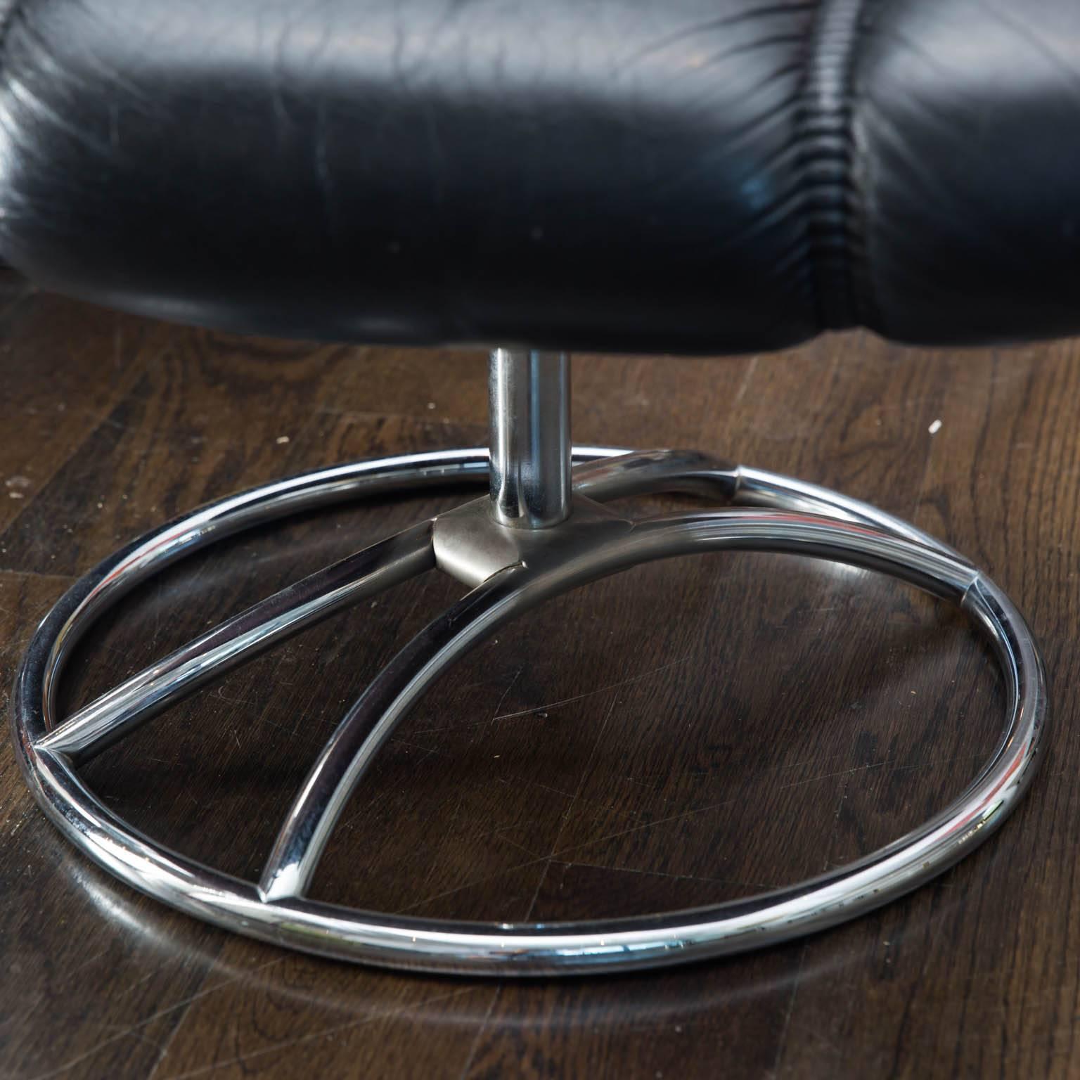 This is a Classic black leather recliner and ottoman from Norwegian maker Ekornes. This most likely is from the 1970s.