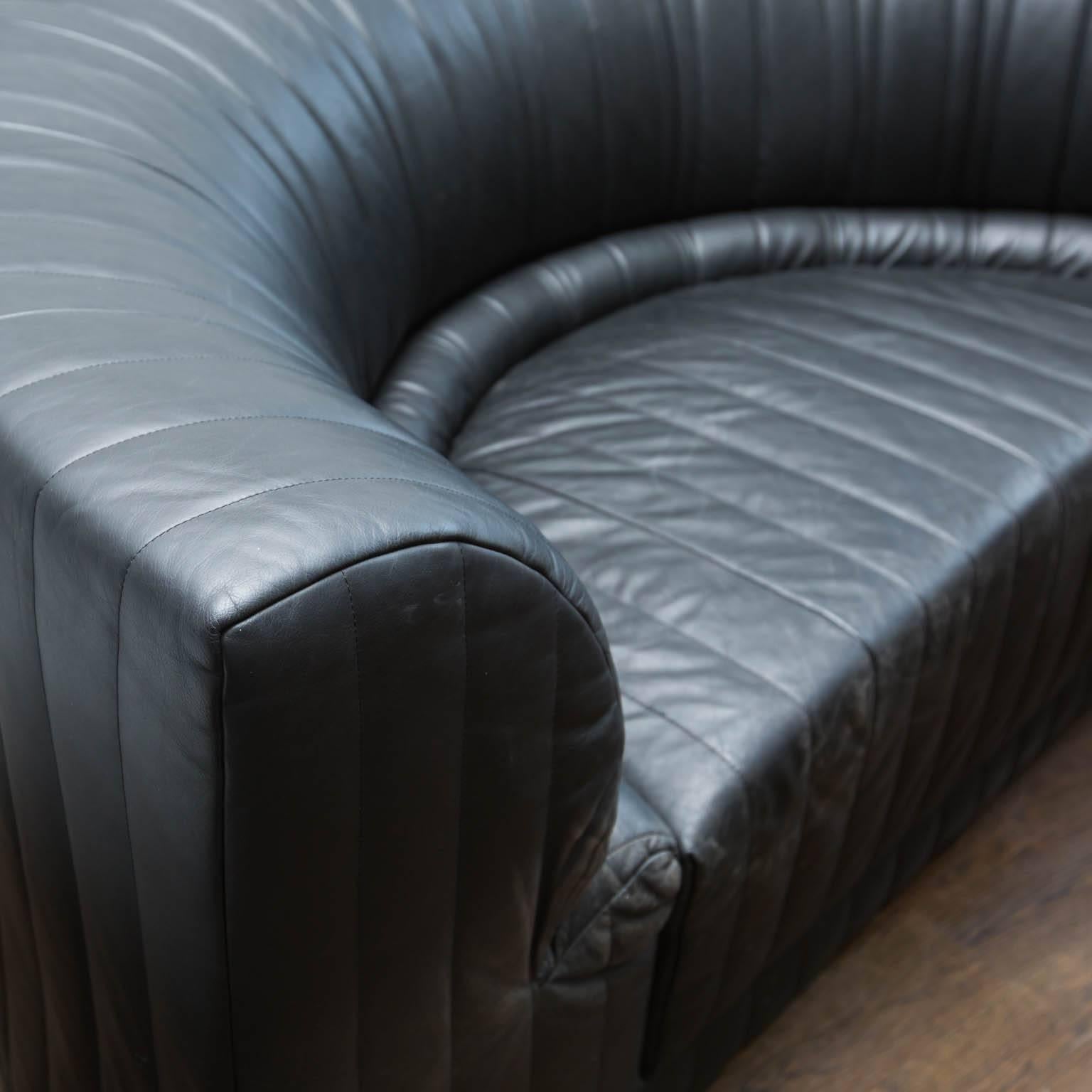 Modern concave shaped leather couch in very clean condition. No rips or scratches to leather. Leather is as soft and subtle as it was the day it was delivered.