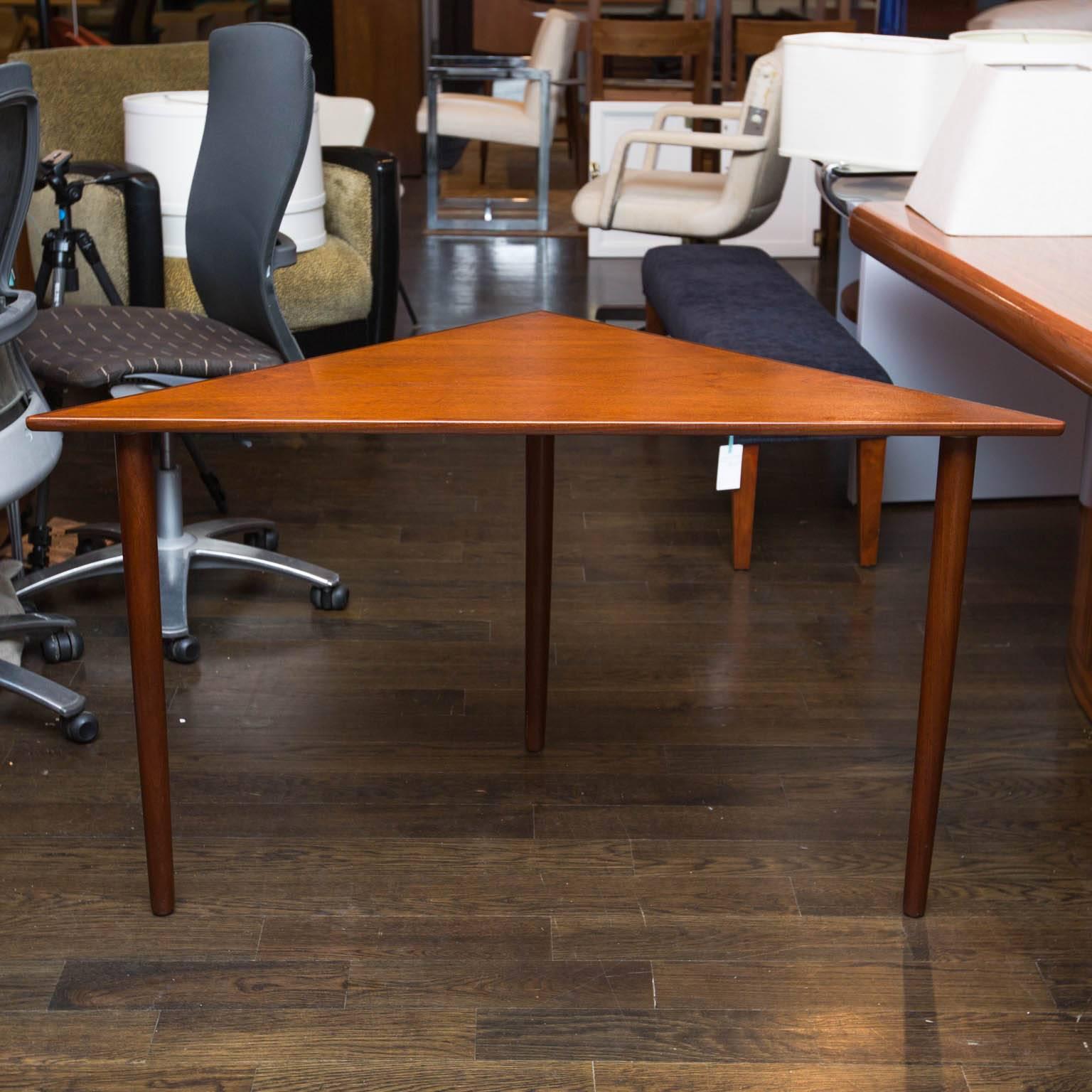 Made from teak veneers with a rosewood edge, this table is perfect table to anchor that corner two piece sectional. Branded with what appear to be a CF on bottom.